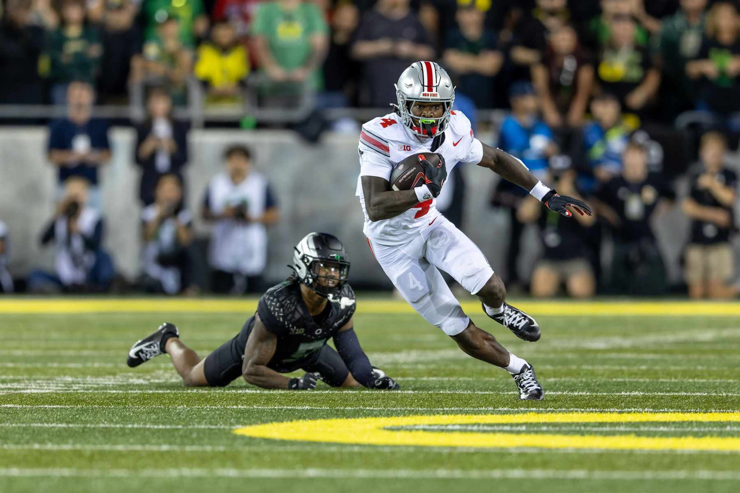 EUGENE, OREGON - OCTOBER 12: Wide receiver Jeremiah Smith #4 of the Ohio State Buckeyes runs against the Oregon Ducks at Autzen Stadium on October 12, 2024 in Eugene, Oregon. (Photo by Tom Hauck/Getty Images)
