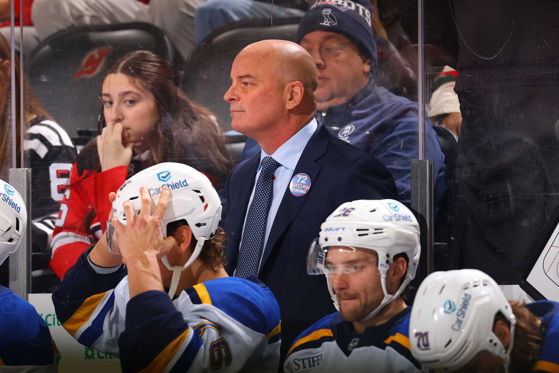 NEWARK, NJ - NOVEMBER 27: Jim Montgomery of the St. Louis Blues behind the bench in the first period of the game against the New Jersey Devils at the Prudential Center on November 27, 2024 in Newark, New Jersey.  (Photo by Rich Graessle/NHLI via Getty Images)