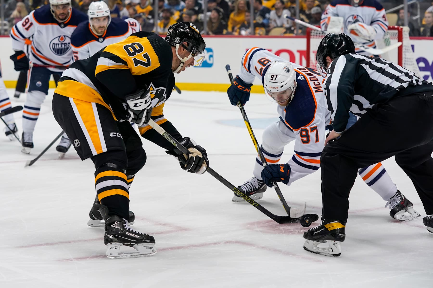 PITTSBURGH, PA - APRIL 26: Pittsburgh Penguins Center Sidney Crosby (87) and Edmonton Oilers Center Connor McDavid (97) face-off during the first period in the NHL game between the Pittsburgh Penguins and the Edmonton Oilers on April 26, 2022, at PPG Paints Arena in Pittsburgh, PA. (Photo by Jeanine Leech/Icon Sportswire via Getty Images)