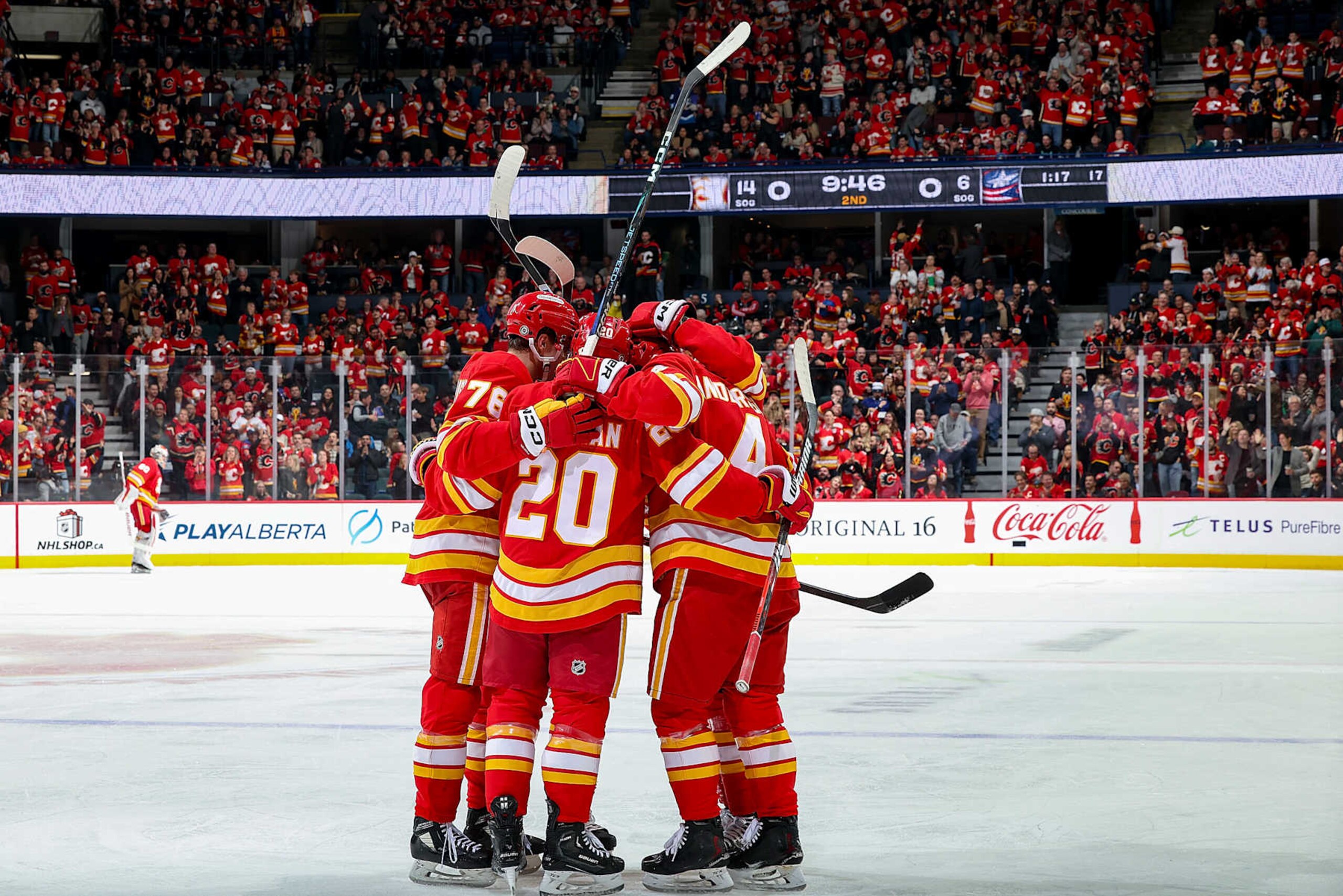 CALGARY, AB - DECEMBER 3: Rasmus Andersson #4 of the Calgary Flames celebrates with teammates after a goal against the Columbus Blue Jackets at Scotiabank Saddledome on December 3, 2024 in Calgary, Alberta, Canada. (Photo by Gerry Thomas/NHLI via Getty Images)