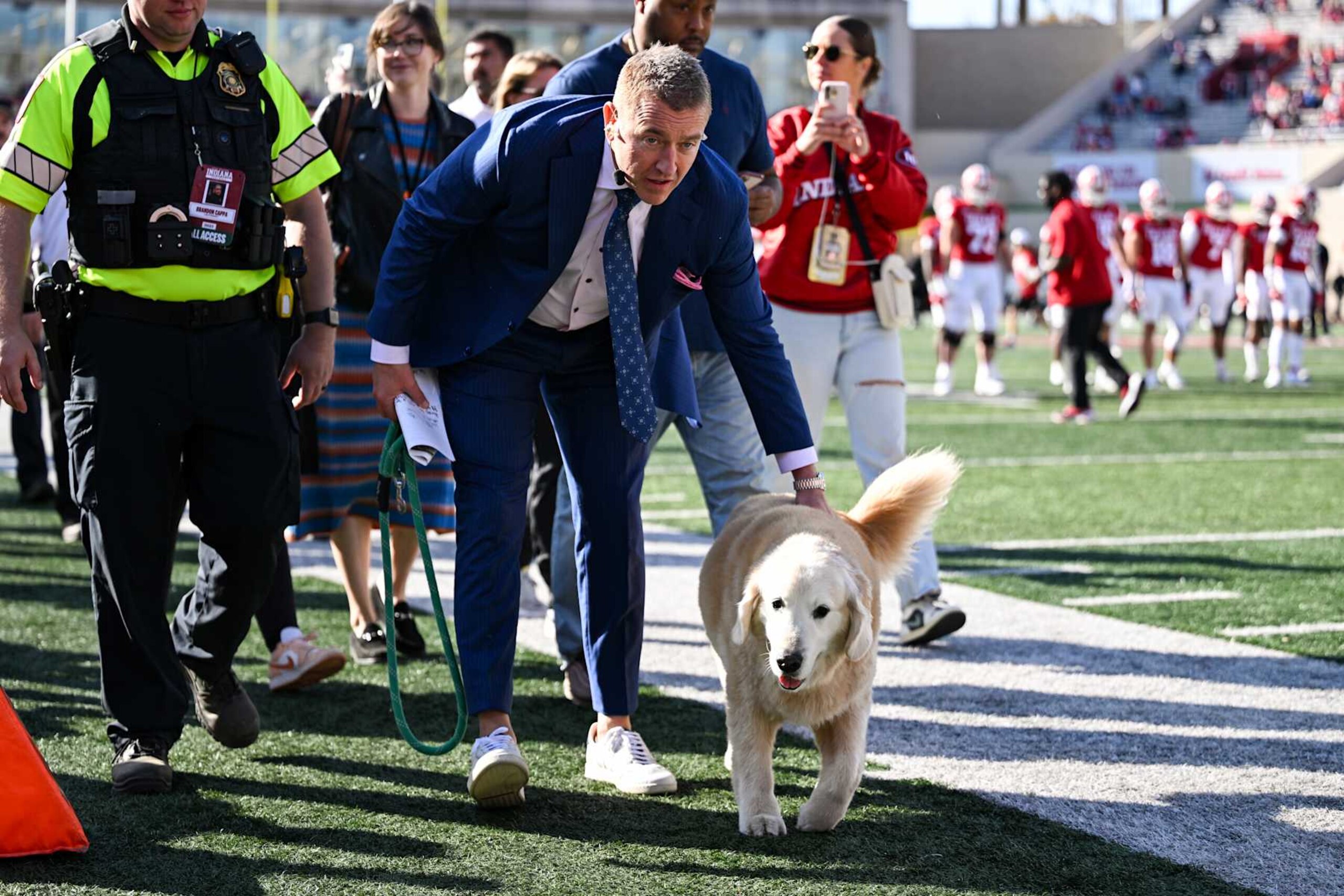 BLOOMINGTON, IN - OCTOBER 26: ESPN College GameDay analyst Kirk Herbstreit walks onto the field with his dog Ben prior to a college football game between the Washington Huskies and Indiana Hoosiers on October 26, 2024 at Memorial Stadium in Bloomington, IN (Photo by James Black/Icon Sportswire via Getty Images)