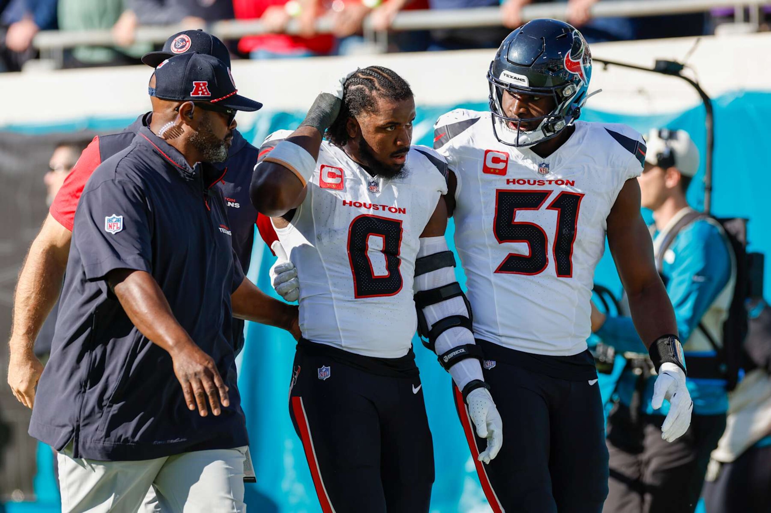 JACKSONVILLE, FL - DECEMBER 01: Houston Texans linebacker Azeez Al-Shaair (0) is escorted off the field by Houston Texans defensive end Will Anderson Jr. (51) after being ejected from the game between the Jacksonville Jaguars and the Houston Texans on December 1, 2024 at EverBank Stadium in Jacksonville, Fl. (Photo by David Rosenblum/Icon Sportswire via Getty Images)