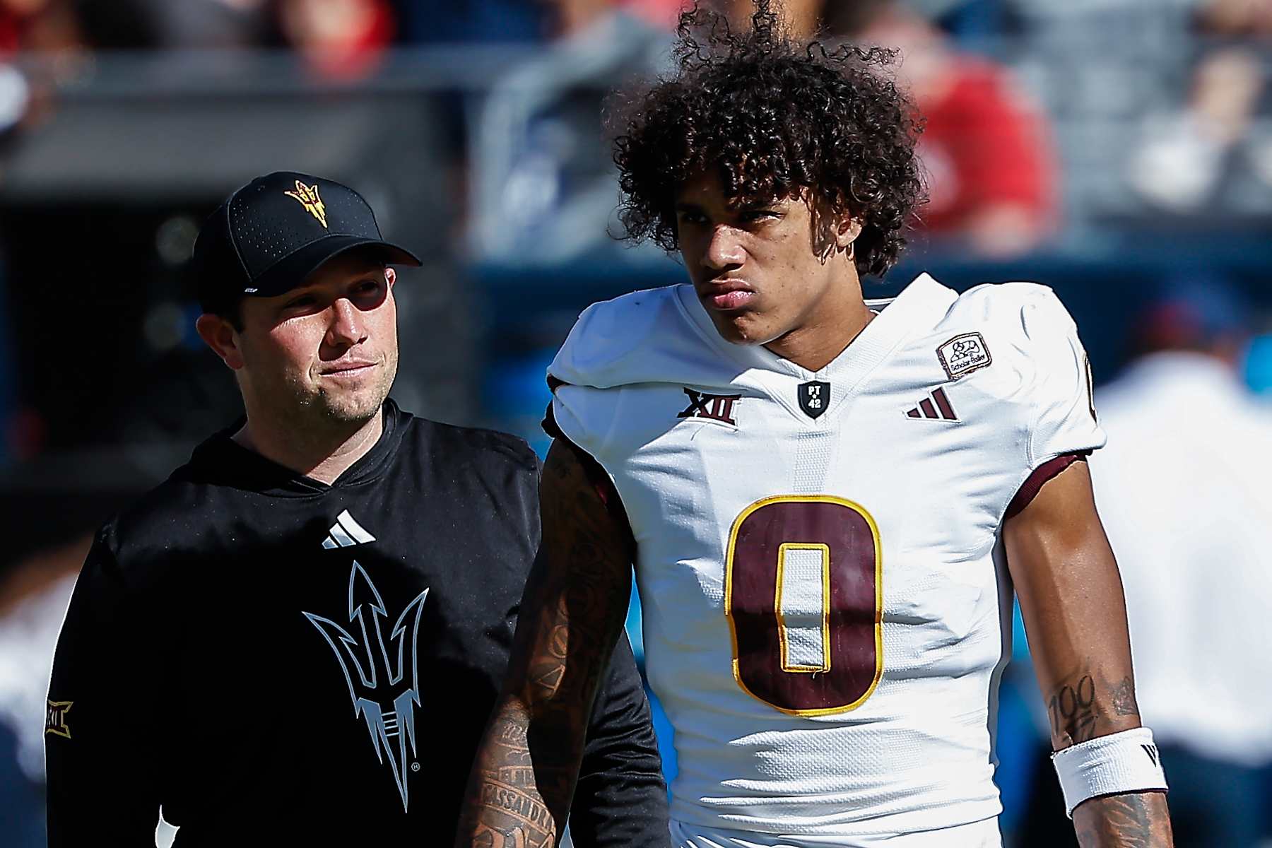 TUCSON, AZ - NOVEMBER 30:  Arizona State Sun Devils head coach Kenny Dillingham and Arizona State Sun Devils wide receiver Jordyn Tyson (0) look on before the college football game between the Arizona State Sun Devils and the Arizona Wildcats on November 30, 2024 at Arizona Stadium in Tucson, Arizona. (Photo by Kevin Abele/Icon Sportswire via Getty Images)