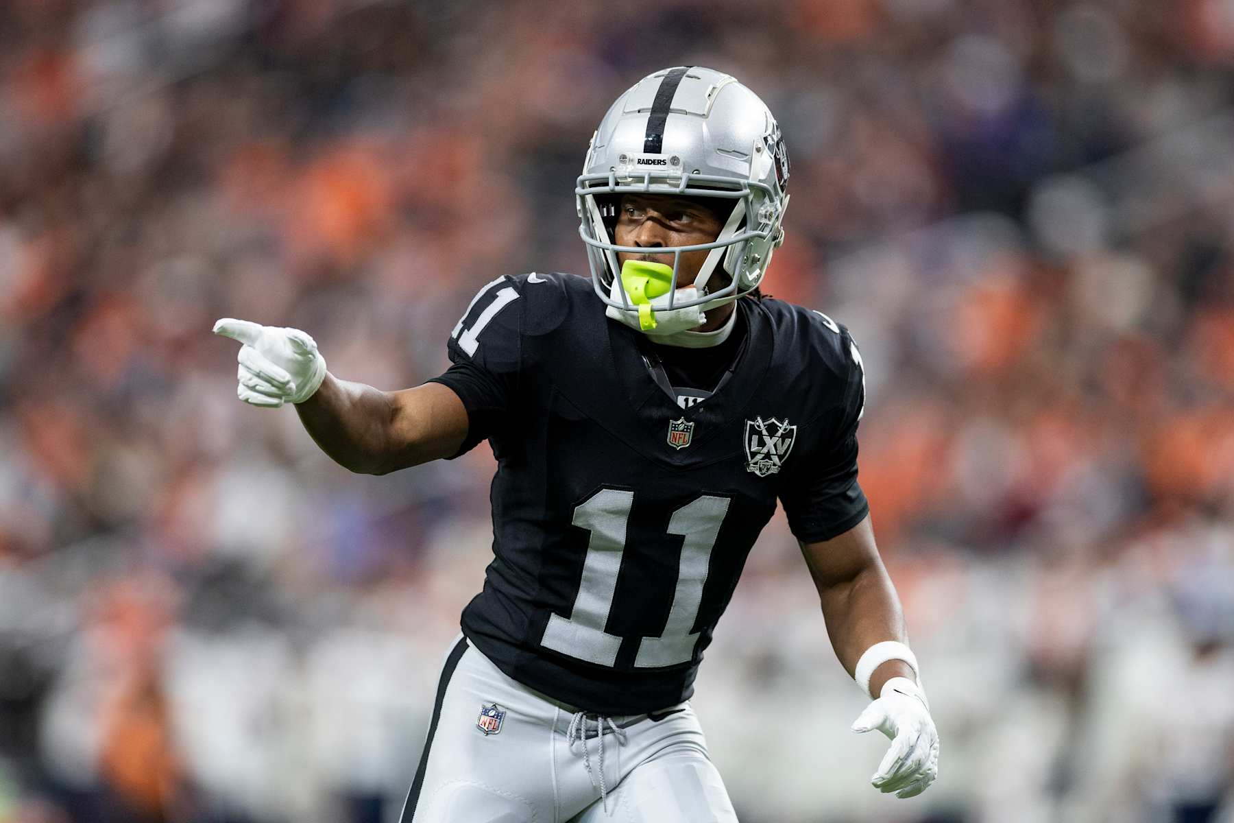 LAS VEGAS, NEVADA - NOVEMBER 24: Tre Tucker #11 of the Las Vegas Raiders signals as he lines up during an NFL Football game against the Denver Broncos at Allegiant Stadium on November 24, 2024 in Las Vegas, Nevada. (Photo by Michael Owens/Getty Images)