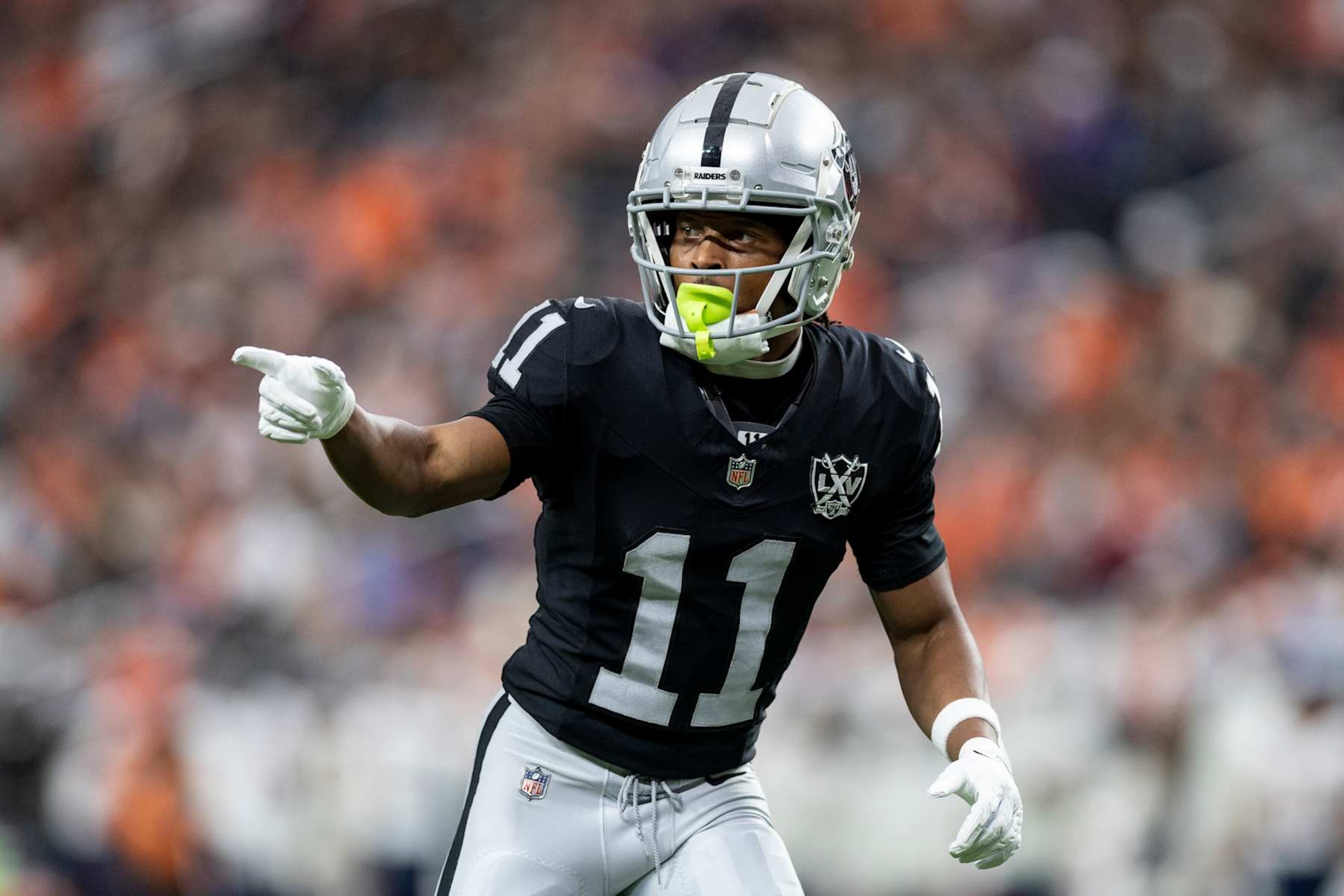 LAS VEGAS, NEVADA - NOVEMBER 24: Tre Tucker #11 of the Las Vegas Raiders signals as he lines up during an NFL Football game against the Denver Broncos at Allegiant Stadium on November 24, 2024 in Las Vegas, Nevada. (Photo by Michael Owens/Getty Images)