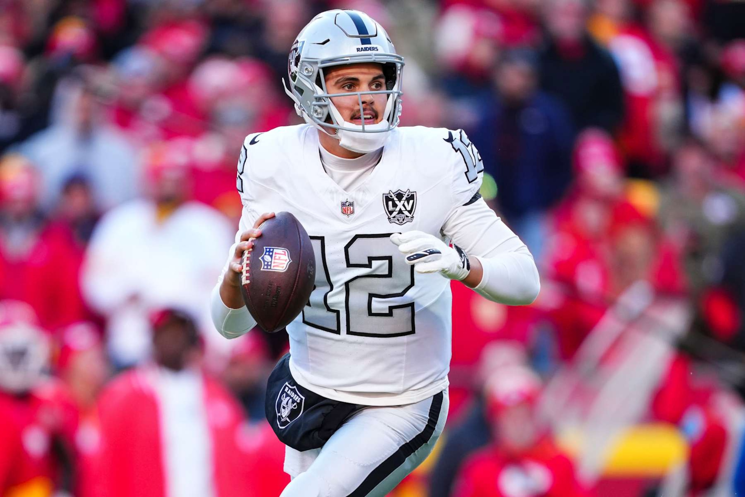 KANSAS CITY, MO - NOVEMBER 29: Aidan O'Connell #12 of the Las Vegas Raiders drops back to pass during an NFL football game against the Kansas City Chiefs at GEHA Field at Arrowhead Stadium on November 29, 2024 in Kansas City, Missouri. (Photo by Cooper Neill/Getty Images)