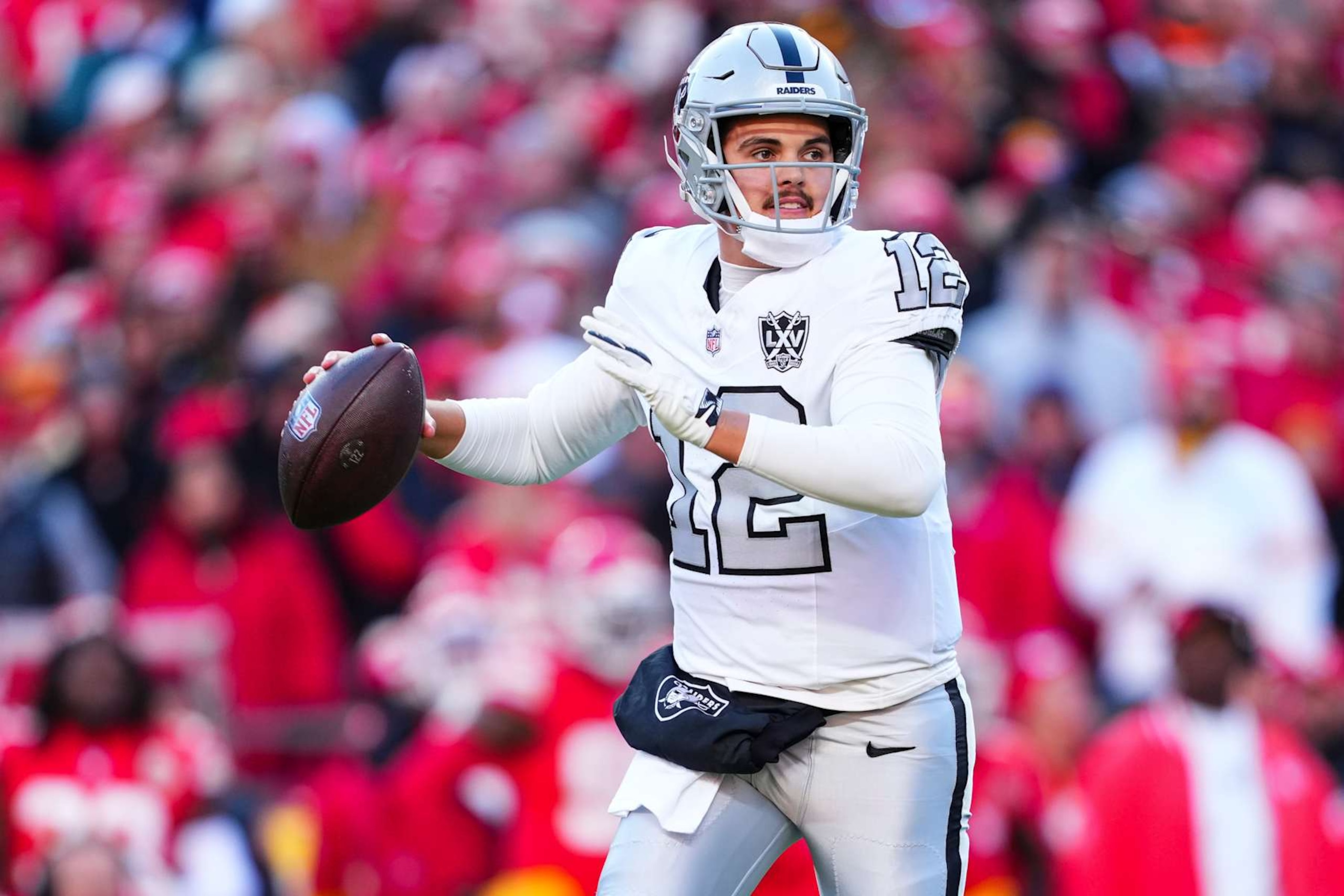 KANSAS CITY, MO - NOVEMBER 29: Aidan O'Connell #12 of the Las Vegas Raiders throws the ball during an NFL football game against the Kansas City Chiefs at GEHA Field at Arrowhead Stadium on November 29, 2024 in Kansas City, Missouri. (Photo by Cooper Neill/Getty Images)