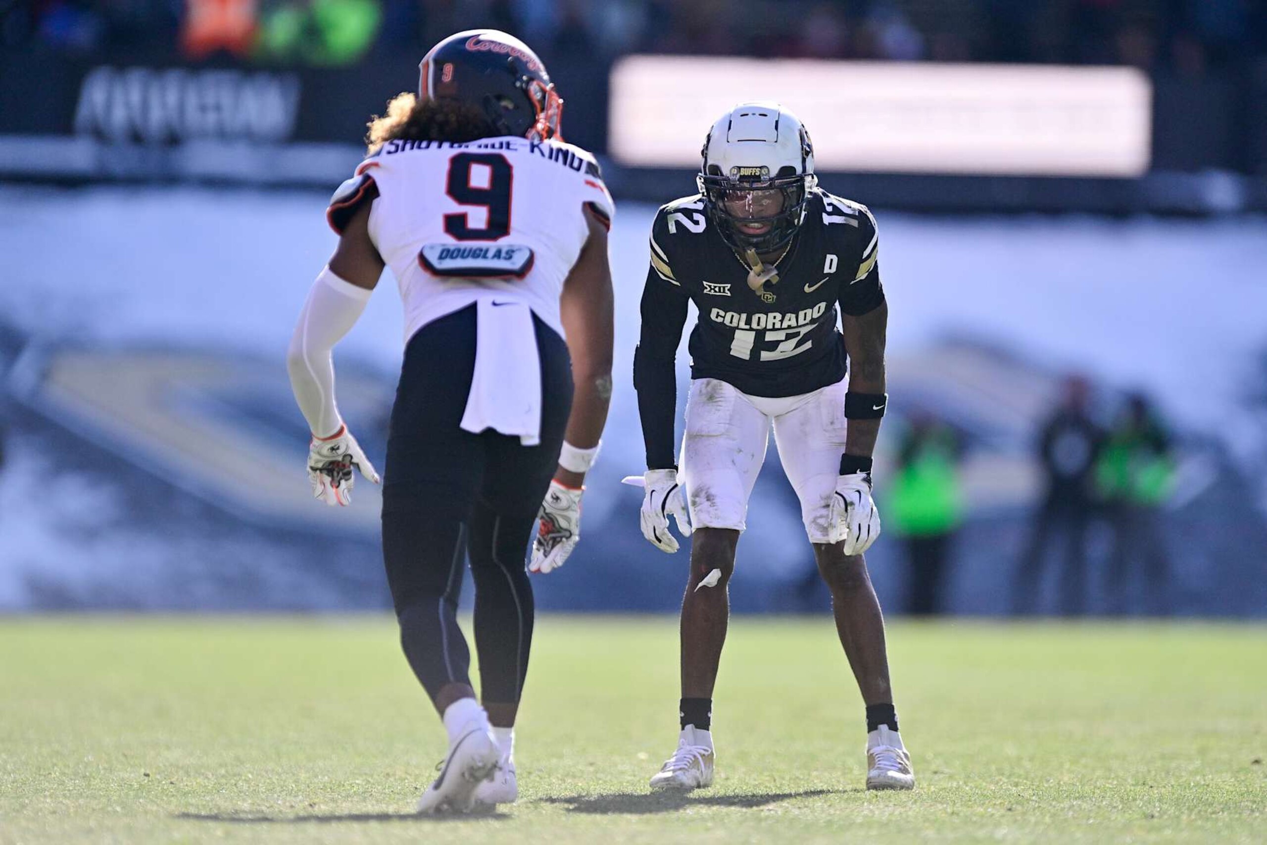 BOULDER, CO - NOVEMBER 29:  Travis Hunter #12 of the Colorado Buffaloes lines up opposite Ayo Shotomide-King #9 of the Oklahoma State Cowboys in the third quarter at Folsom Field on November 29, 2024 in Boulder, Colorado. (Photo by Dustin Bradford/Getty Images)