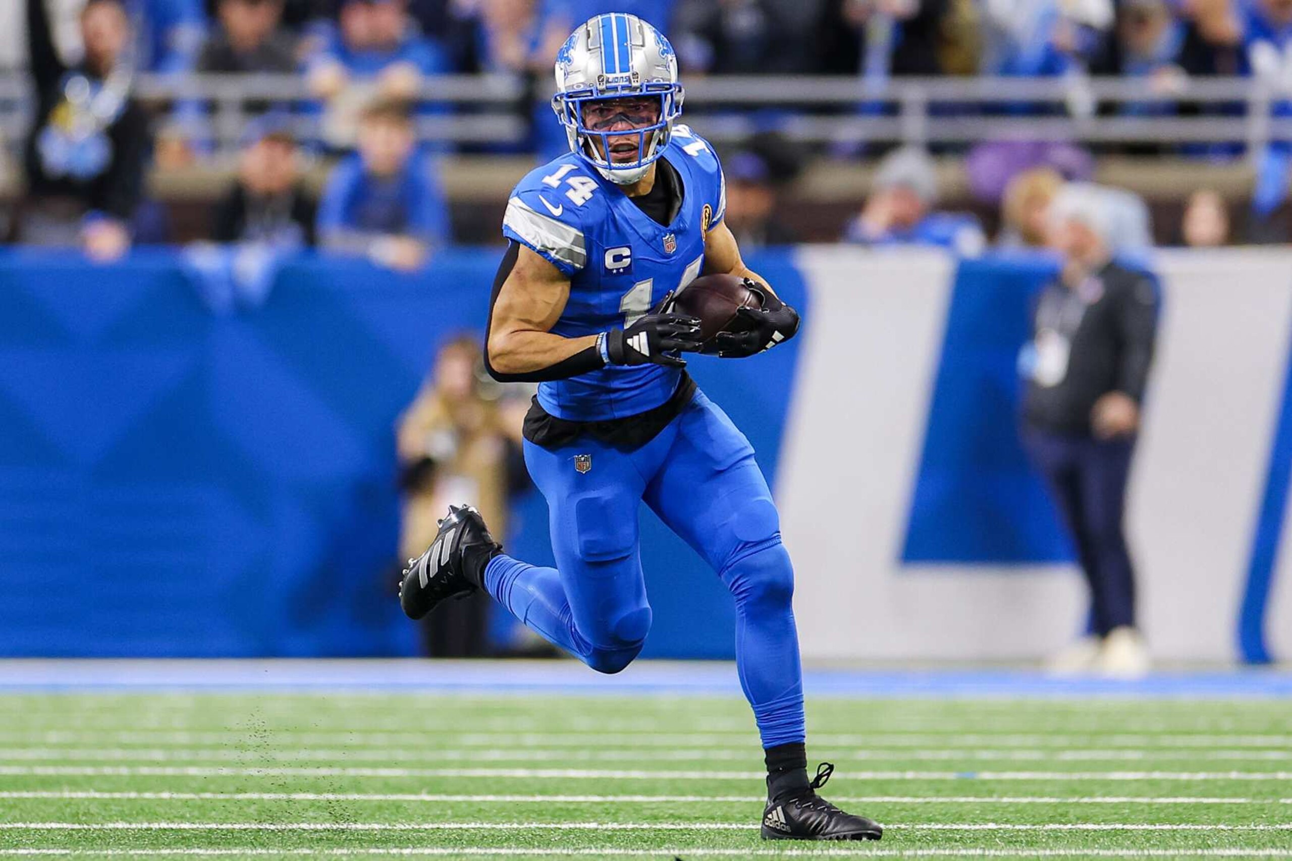 DETROIT, MICHIGAN - NOVEMBER 28: Amon-Ra St. Brown #14 of the Detroit Lions runs the ball up the field after catching a pass during the first half of a game against the Chicago Bears at Ford Field on November 28, 2024 in Detroit, Michigan. (Photo by Mike Mulholland/Getty Images)