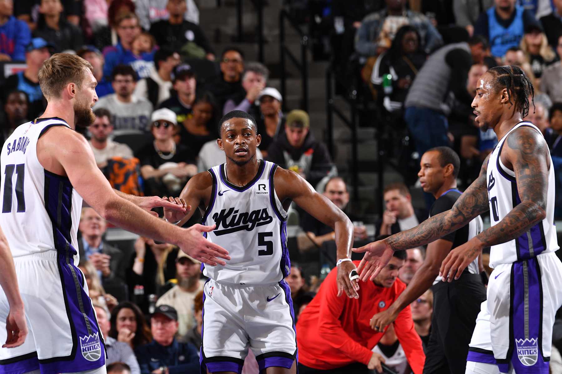 INGLEWOOD, CA - NOVEMBER 22: De'Aaron Fox #5, Domantas Sabonis #11, and DeMar DeRozan #10 of the Sacramento Kings high five during the game against the LA Clippers during the Emirates NBA Cup game on November 22, 2024 at the Intuit Dome in Los Angeles, California. NOTE TO USER: User expressly acknowledges and agrees that, by downloading and/or using this Photograph, user is consenting to the terms and conditions of the Getty Images License Agreement. Mandatory Copyright Notice: Copyright 2024 NBAE (Photo by Juan Ocampo/NBAE via Getty Images)