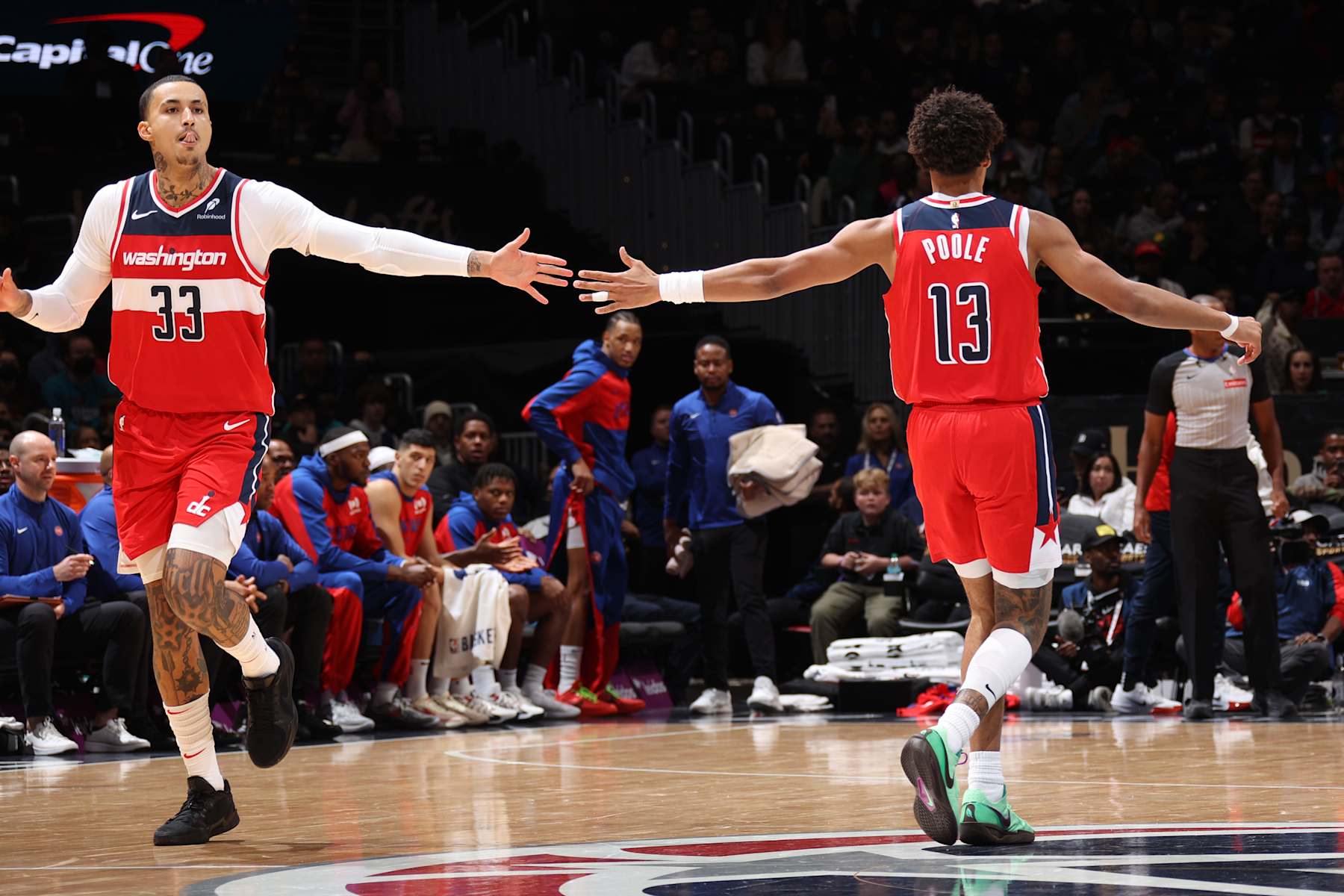 WASHINGTON, DC -  NOVEMBER 17: Kyle Kuzma #33 and Jordan Poole #13 of the Washington Wizards high five during the game against the Detroit Pistons on November 17, 2024 at Capital One Arena in Washington, DC. NOTE TO USER: User expressly acknowledges and agrees that, by downloading and or using this Photograph, user is consenting to the terms and conditions of the Getty Images License Agreement. Mandatory Copyright Notice: Copyright 2024 NBAE (Photo by Stephen Gosling/NBAE via Getty Images)