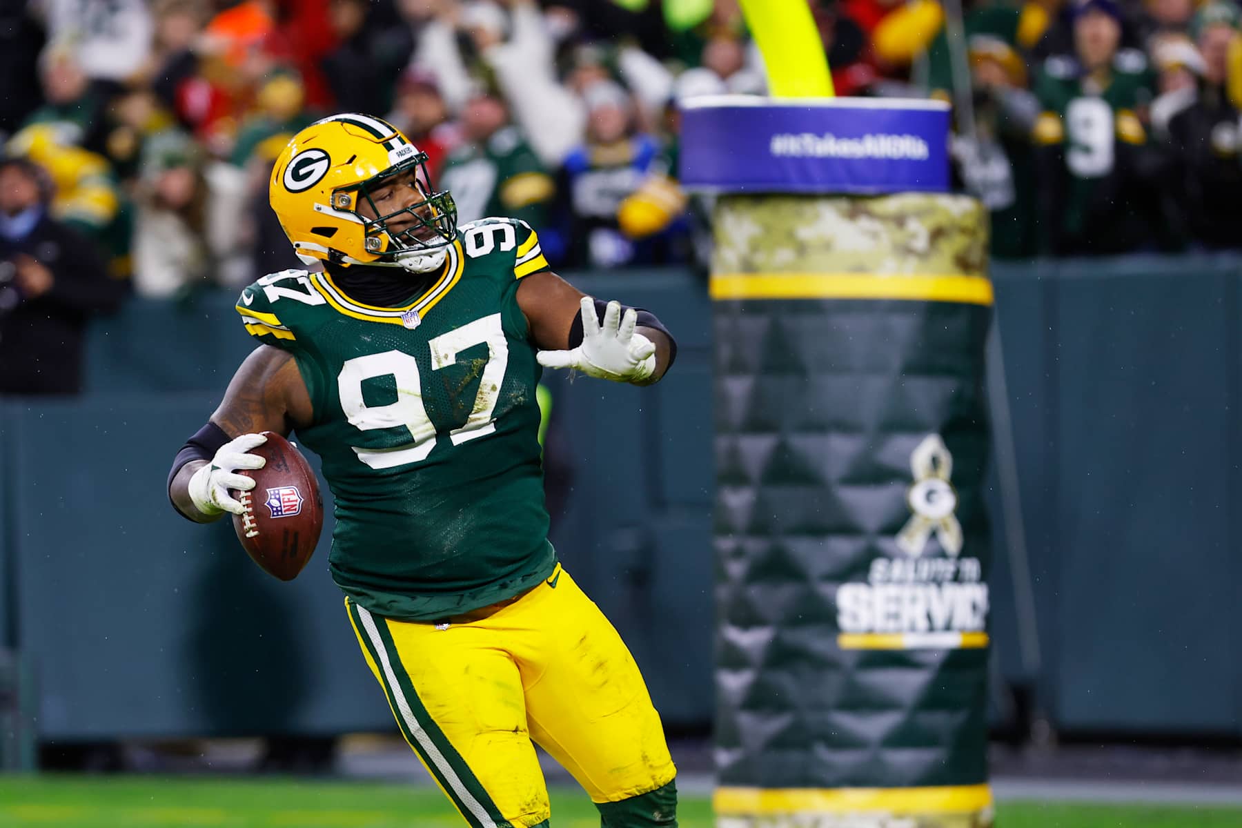 GREEN BAY, WI - NOVEMBER 24: Green Bay Packers defensive tackle Kenny Clark (97) throws his fumble recovery into the stands during a game between the Green Bay Packers and the San Francisco 49ers at Lambeau Field on November 24, 2024 in Green Bay, WI. (Photo by Larry Radloff/Icon Sportswire via Getty Images)