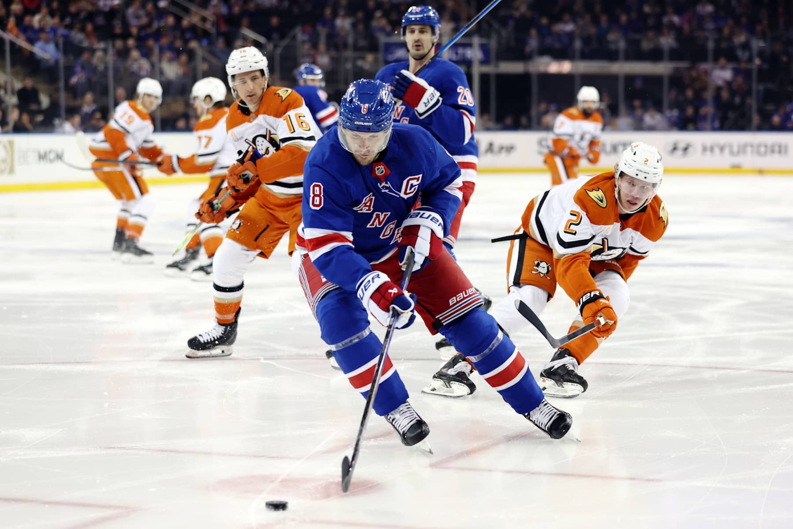 NEW YORK, NEW YORK - OCTOBER 26: Jacob Trouba #8 of the New York Rangers controls the puck as Jackson LaCombe #2 and Ryan Strome #16 of the Anaheim Ducks defend during the first period at Madison Square Garden on October 26, 2024 in New York City. (Photo by Sarah Stier/Getty Images)
