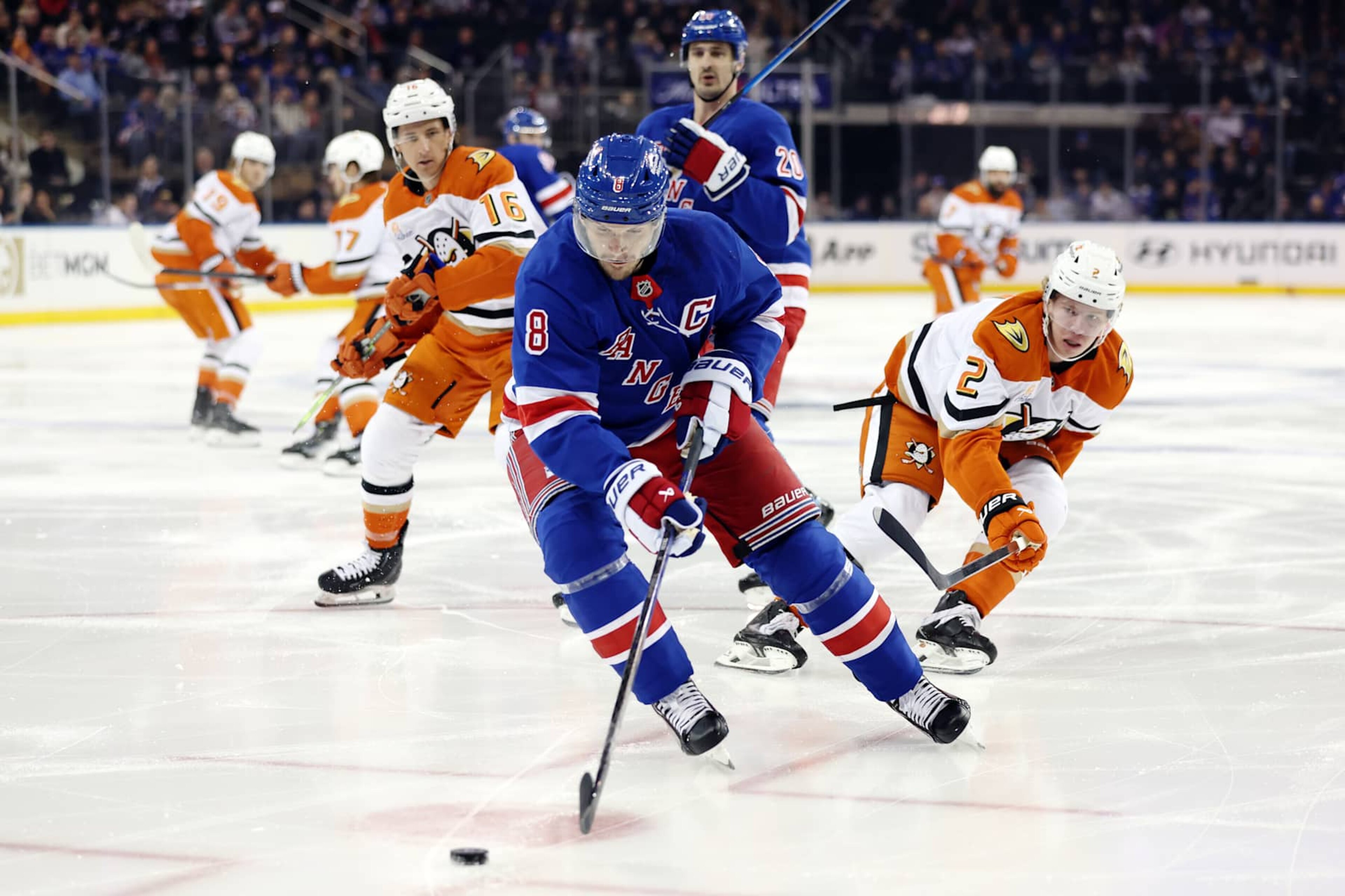 NEW YORK, NEW YORK - OCTOBER 26: Jacob Trouba #8 of the New York Rangers controls the puck as Jackson LaCombe #2 and Ryan Strome #16 of the Anaheim Ducks defend during the first period at Madison Square Garden on October 26, 2024 in New York City. (Photo by Sarah Stier/Getty Images)