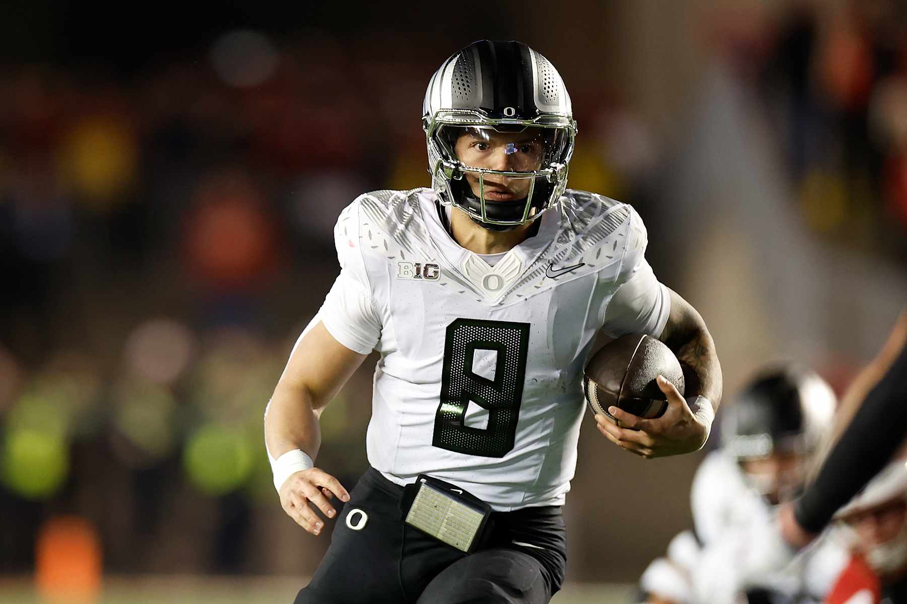 MADISON, WISCONSIN - NOVEMBER 16: Dillon Gabriel #8 of the Oregon Ducks runs with the ball for a first down late in the game against the Wisconsin Badgers at Camp Randall Stadium on November 16, 2024 in Madison, Wisconsin. (Photo by John Fisher/Getty Images)