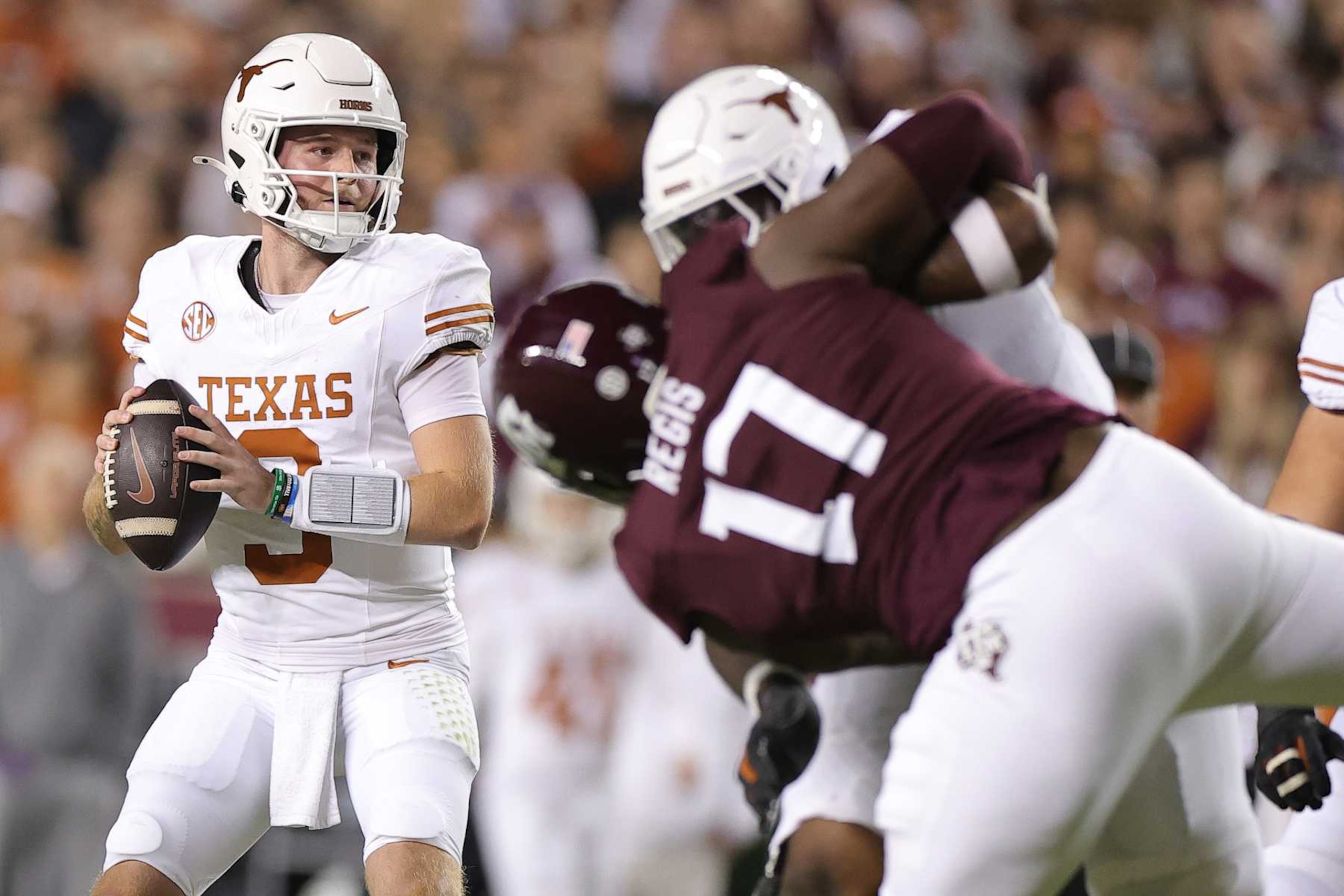 COLLEGE STATION, TEXAS - NOVEMBER 30: Quinn Ewers #3 of the Texas Longhorns drops back to pass against the Texas A&M Aggies during the first half at Kyle Field on November 30, 2024 in College Station, Texas.  (Photo by Alex Slitz/Getty Images)