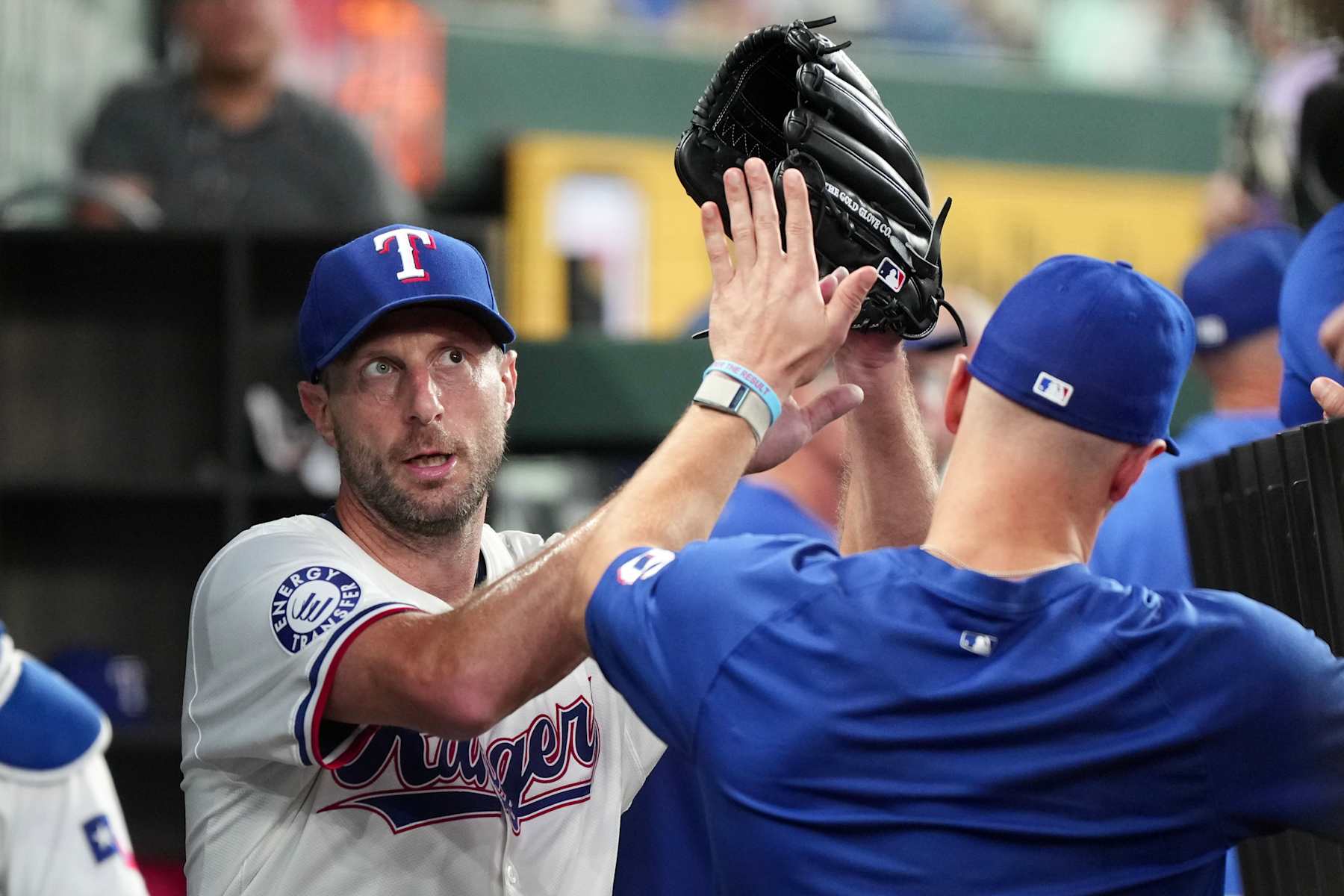 ARLINGTON, TEXAS - JULY 25: Max Scherzer #31 of the Texas Rangers is congratulated in his dugout after the sixth inning against the Chicago White Sox at Globe Life Field on July 25, 2024 in Arlington, Texas. During the game, Scherzer became the 10th pitcher in MLB most strikeouts list of all time. (Photo by Sam Hodde/Getty Images)