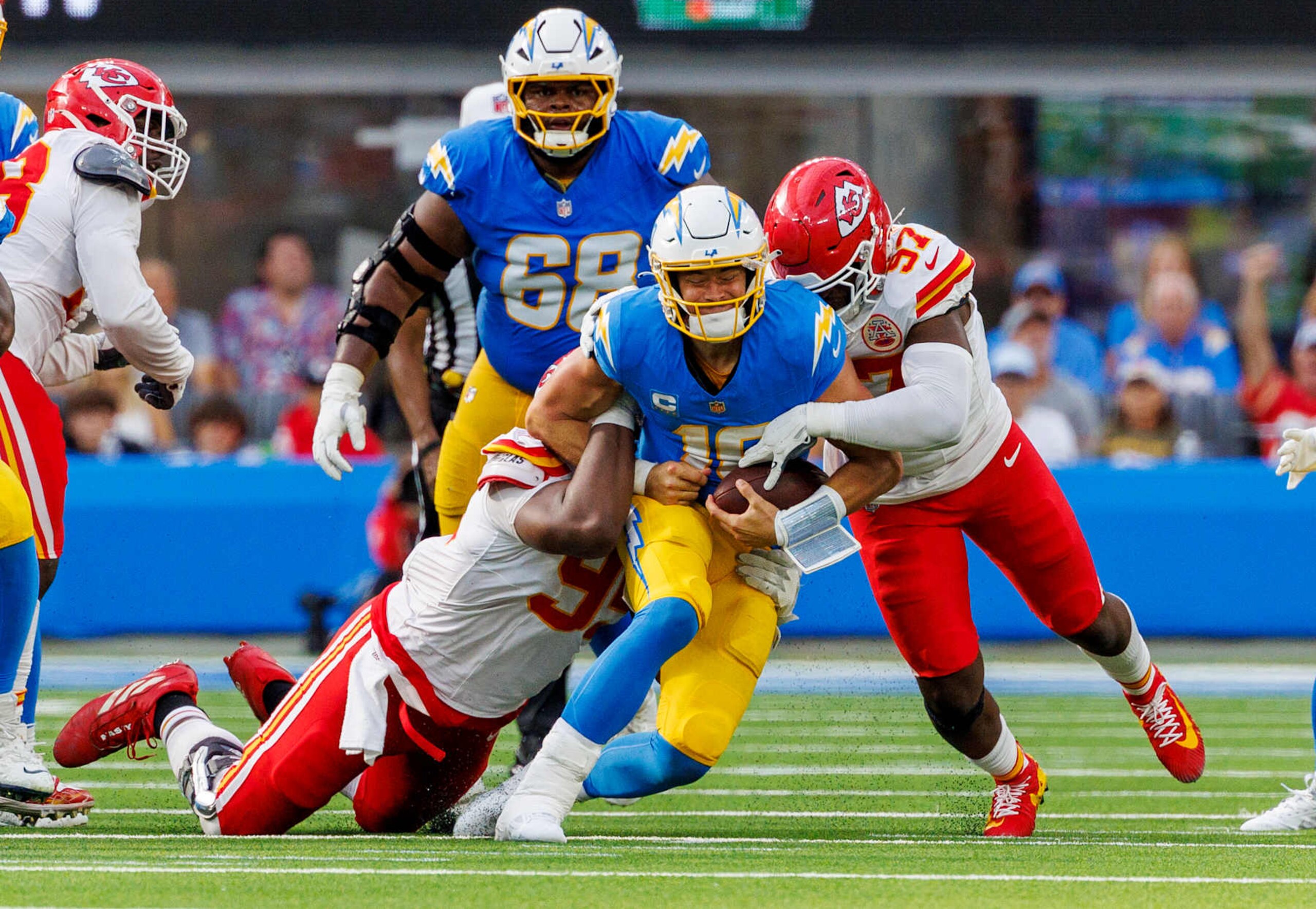INGLEWOOD, CA - SEPTEMBER 29, 2024: Los Angeles Chargers quarterback Justin Herbert (10) is sacked by Kansas City Chiefs defensive tackle Chris Jones (95) and Kansas City Chiefs defensive end Felix Anudike-Uzomah (97) in the fourth quarter  at the So-Fi Stadium on September 29, 2024 in Inglewood, California. (Gina Ferazzi / Los Angeles Times via Getty Images)