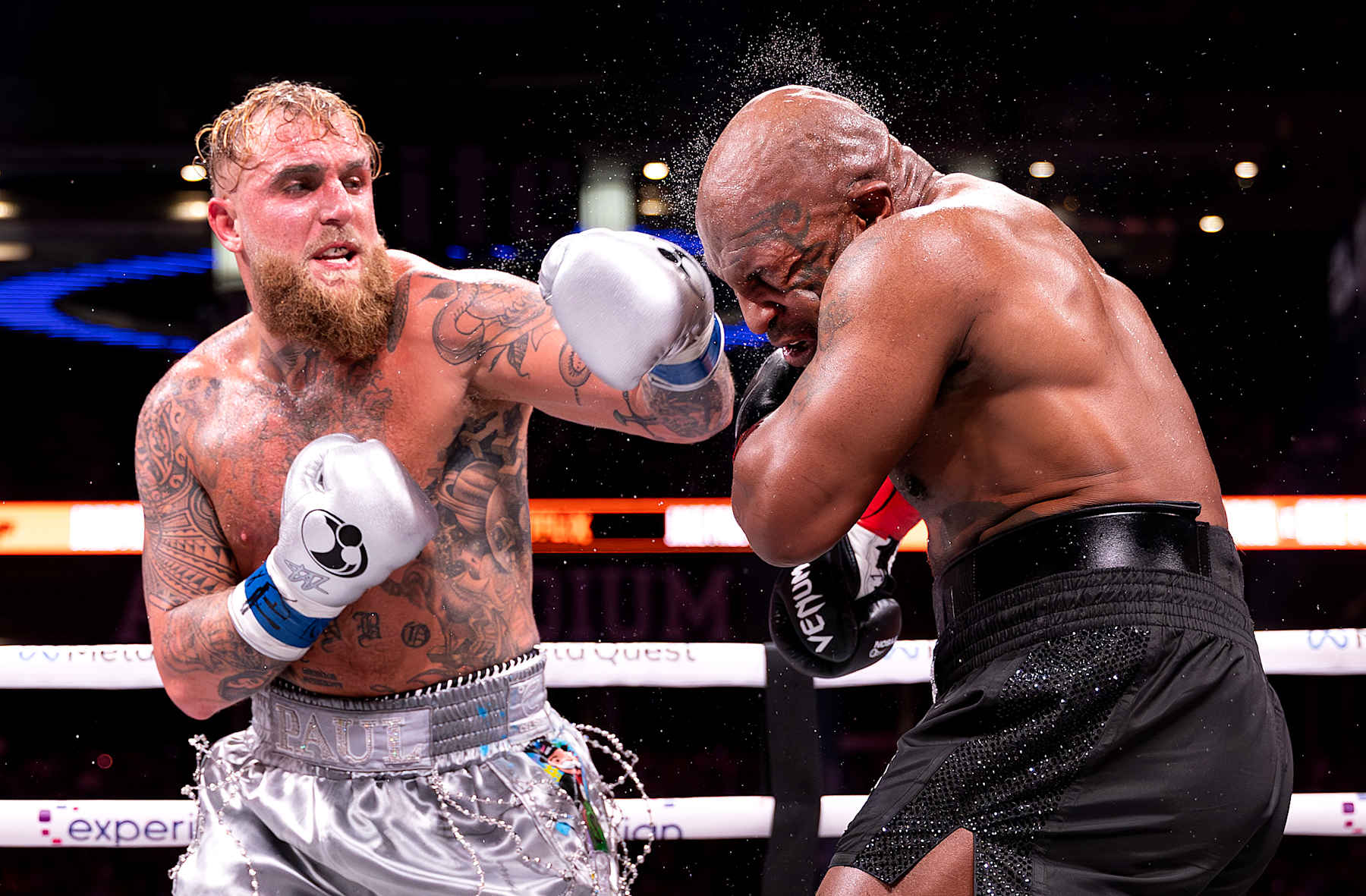 ARLINGTON, TEXAS - NOVEMBER 15:  Jake Paul punches Mike Tyson during LIVE On Netflix: Jake Paul vs. Mike Tyson at AT&T Stadium on November 15, 2024 in Arlington, Texas.  (Photo by Al Bello/Getty Images for Netflix © 2024)