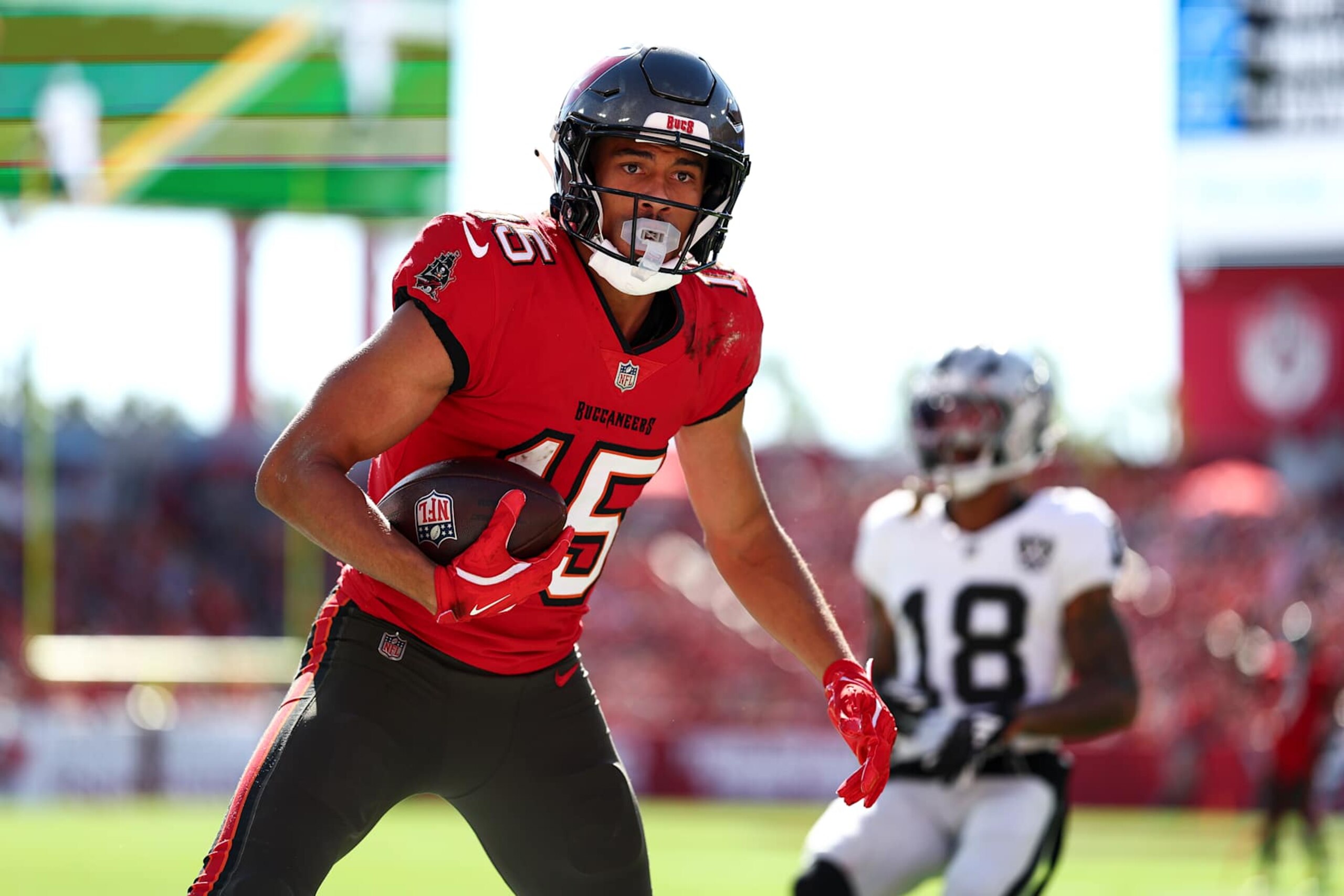 TAMPA, FLORIDA - DECEMBER 8: Jalen McMillan #15 of the Tampa Bay Buccaneers scores a touchdown during the first half of an NFL football game against the Las Vegas Raiders at Raymond James Stadium on December 8, 2024 in Tampa, Florida. (Photo by Kevin Sabitus/Getty Images)