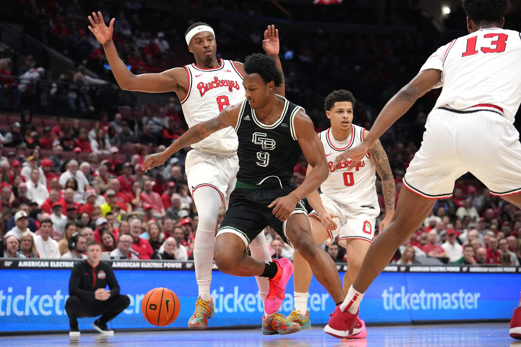 COLUMBUS, OH - NOVEMBER 25: Green Bay Phoenix guard Anthony Roy (9) looses the ball as he drives to the basket against Ohio State Buckeyes guard Micah Parrish (8) during the first half of the game between the Ohio State Buckeyes and the Green Bay Phoenix at Value City Arena in Columbus, Ohio On November 25, 2024. (Photo by Jason Mowry/Icon Sportswire via Getty Images)