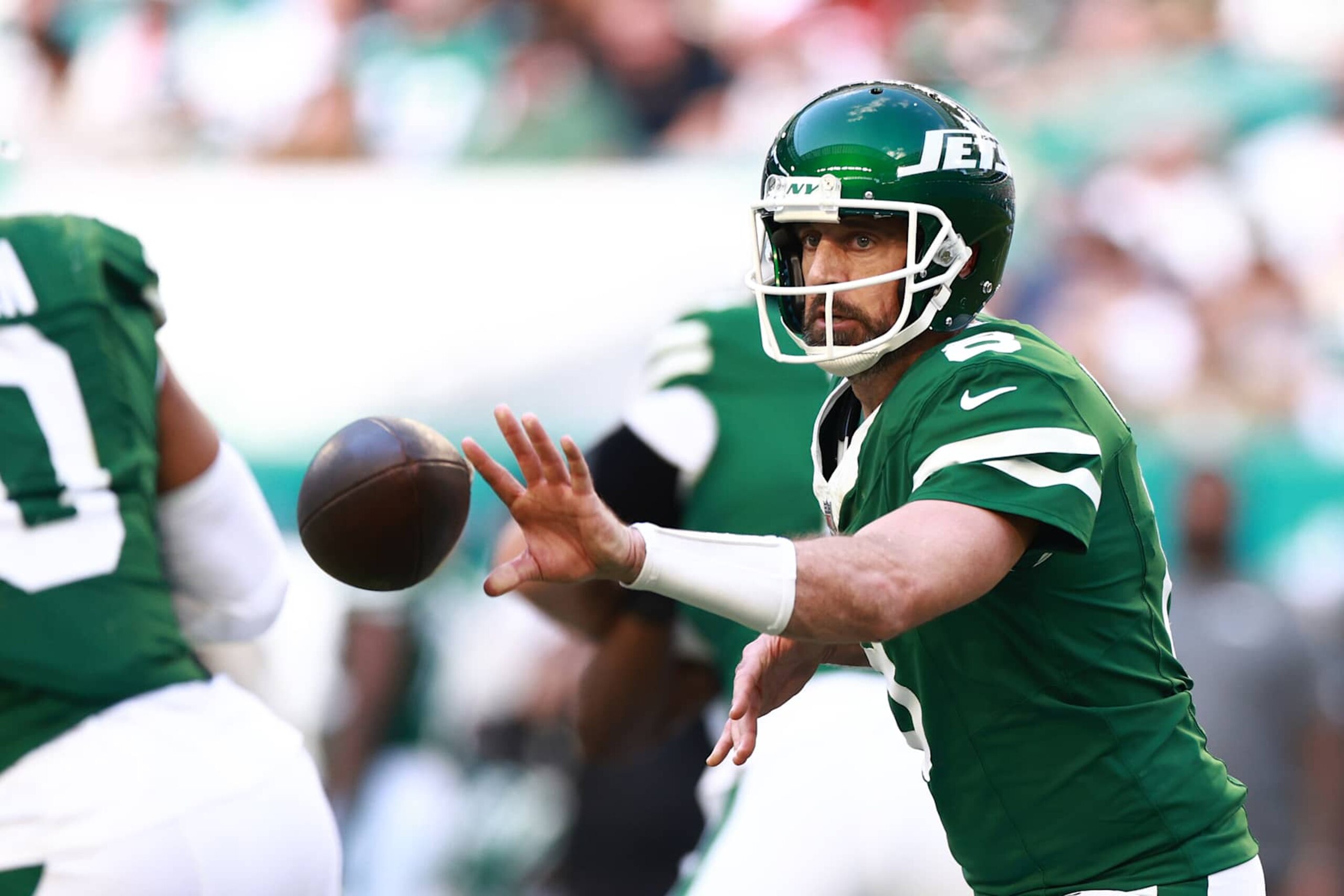MIAMI GARDENS, FLORIDA - DECEMBER 08: Aaron Rodgers #8 of the New York Jets pitches the ball away in the third quarter of a game against the Miami Dolphins at Hard Rock Stadium on December 08, 2024 in Miami Gardens, Florida. (Photo by Carmen Mandato/Getty Images)