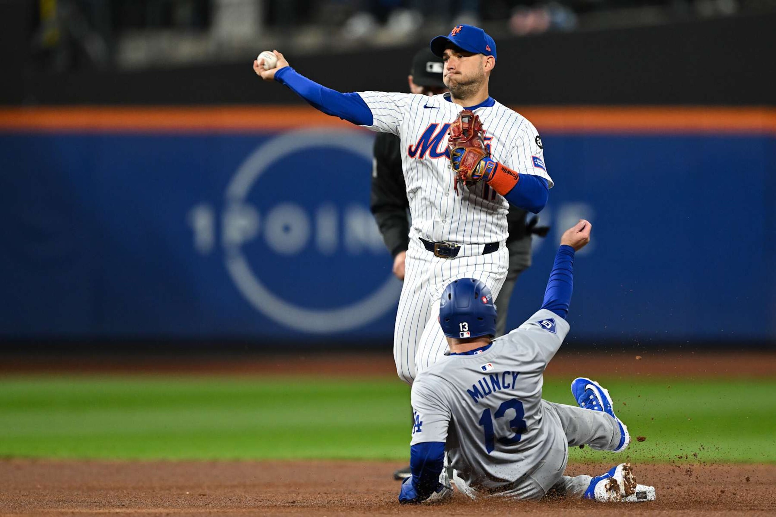NEW YORK, NY - OCTOBER 17:   Jose Iglesias #11 of the New York Mets throws over Max Muncy #13 of the Los Angeles Dodgers for an out in the second inning during Game 4 of the NLCS presented by loanDepot between the Los Angeles Dodgers and the New York Mets at Citi Field on Thursday, October 17, 2024 in New York, New York. (Photo by Drew Hallowell/MLB Photos via Getty Images)