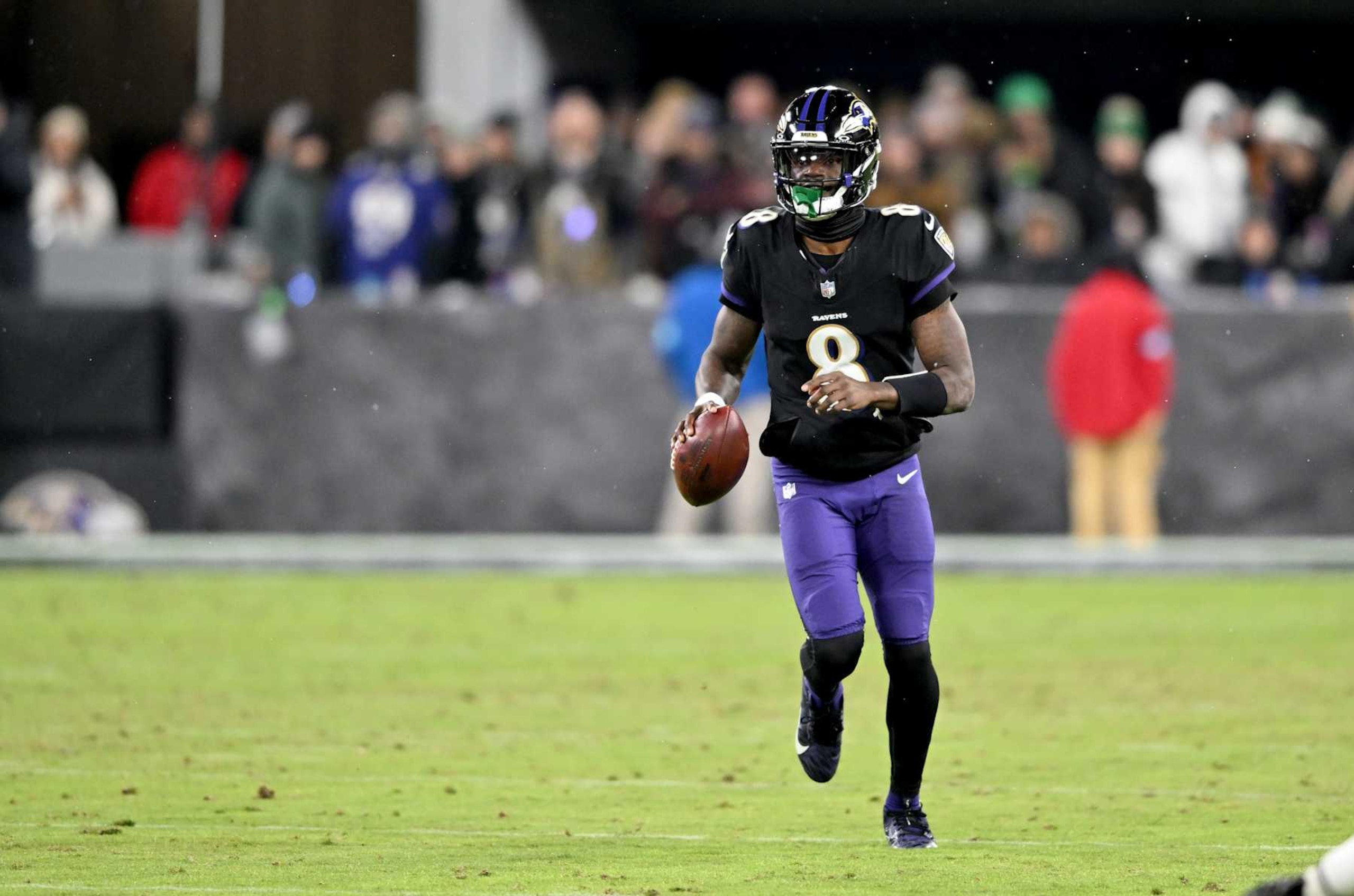 BALTIMORE, MARYLAND - DECEMBER 01: Lamar Jackson #8 of the Baltimore Ravens runs with the ball against the Philadelphia Eagles at M&T Bank Stadium on December 01, 2024 in Baltimore, Maryland. (Photo by G Fiume/Getty Images)