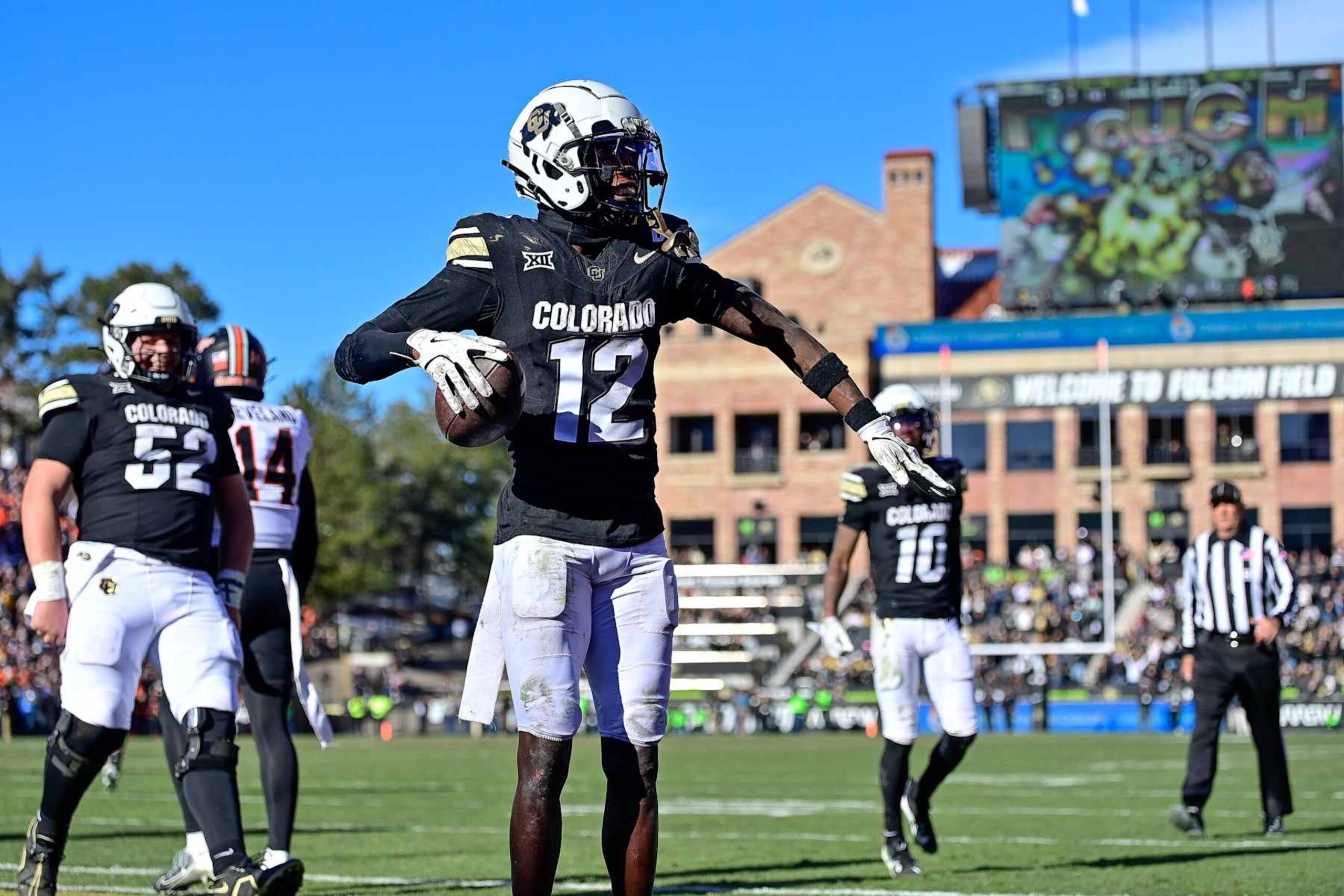 BOULDER, CO - NOVEMBER 29: Travis Hunter #12 of the Colorado Buffaloes celebrates after catching a pass under tight coverage against the Oklahoma State Cowboys for a fourth quarter touchdown at Folsom Field on November 29, 2024 in Boulder, Colorado. (Photo by Dustin Bradford/Getty Images) BOULDER, CO - NOVEMBER 29: Travis Hunter #12 of the Colorado Buffaloes celebrates after catching a pass under tight coverage against the Oklahoma State Cowboys for a fourth quarter touchdown at Folsom Field on November 29, 2024 in Boulder, Colorado. (Photo by Dustin Bradford/Getty Images)