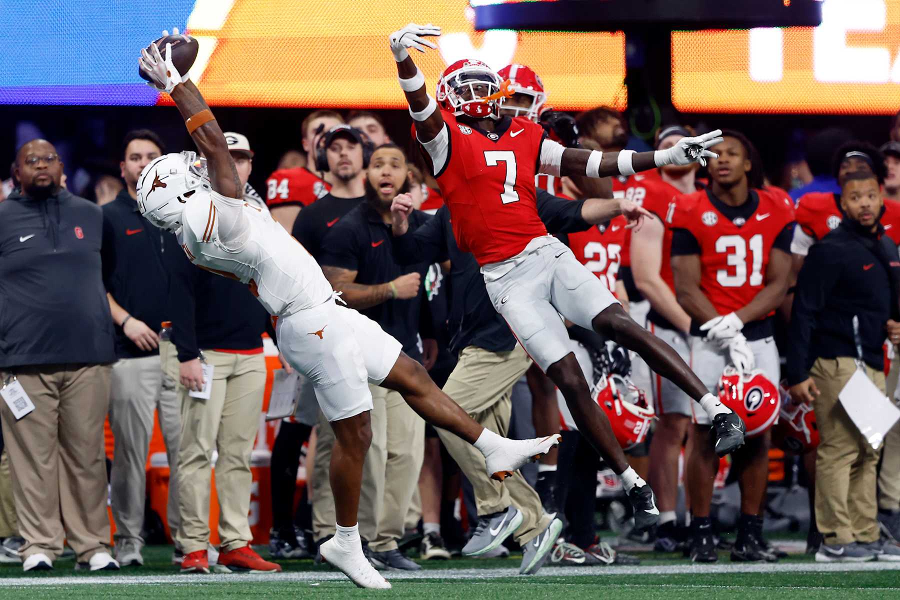 ATLANTA, GEORGIA - DECEMBER 07: Matthew Golden #2 of the Texas Longhorns makes a catch against Daniel Harris #7 of the Georgia Bulldogs during the first quarter of the 2024 SEC Championship at Mercedes-Benz Stadium on December 07, 2024 in Atlanta, Georgia. (Photo by Butch Dill/Getty Images)