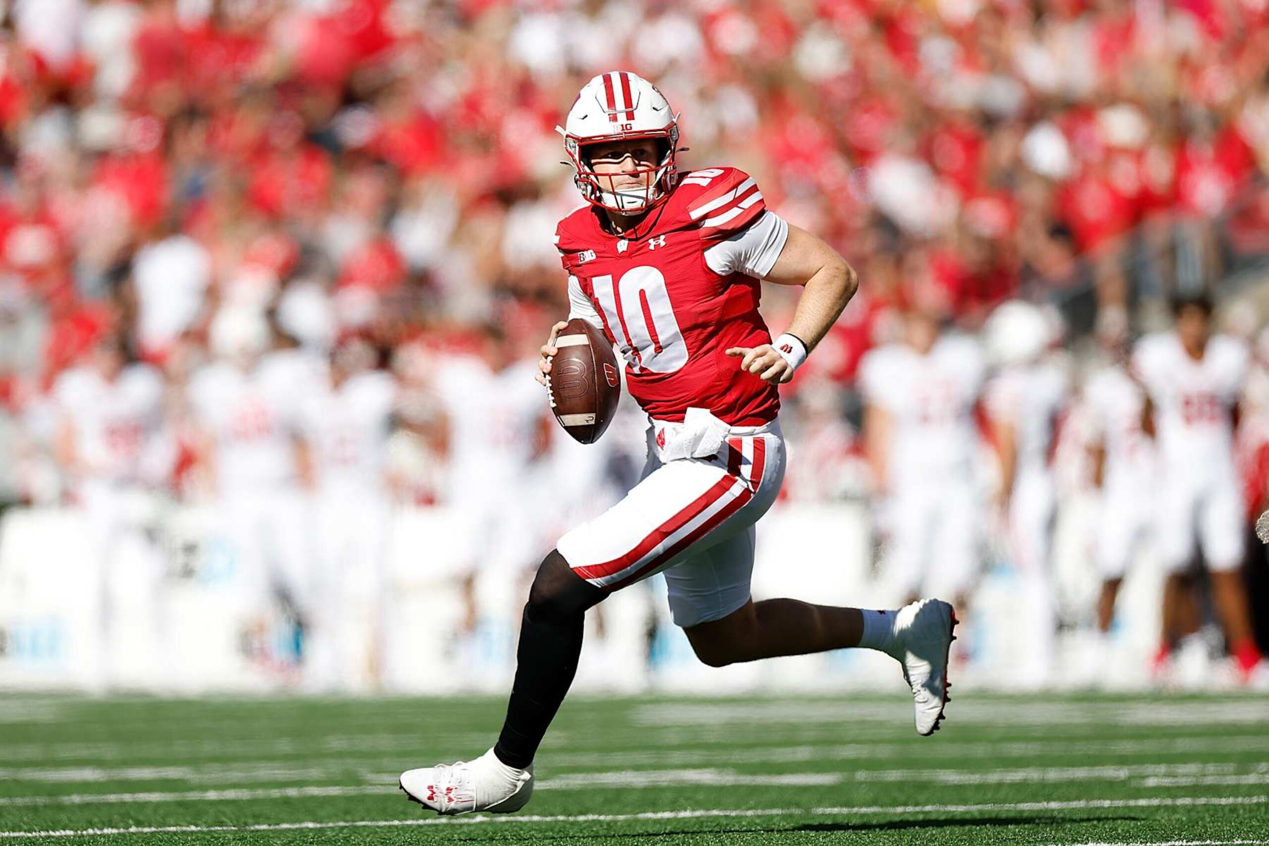 MADISON, WISCONSIN - SEPTEMBER 07: Tyler Van Dyke #10 of the Wisconsin Badgers rolls to his right looking for a receiver in the second quarter against the South Dakota Coyotes at Camp Randall Stadium on September 07, 2024 in Madison, Wisconsin. (Photo by John Fisher/Getty Images)