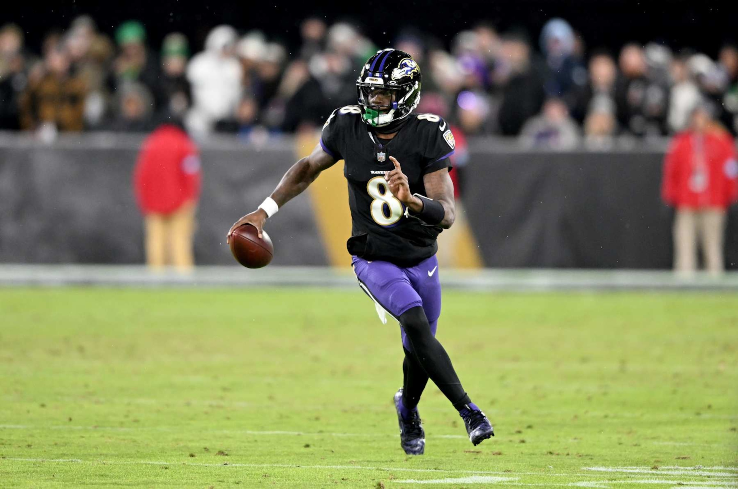 BALTIMORE, MARYLAND - DECEMBER 01: Lamar Jackson #8 of the Baltimore Ravens runs with the ball against the Philadelphia Eagles at M&T Bank Stadium on December 01, 2024 in Baltimore, Maryland. (Photo by G Fiume/Getty Images)