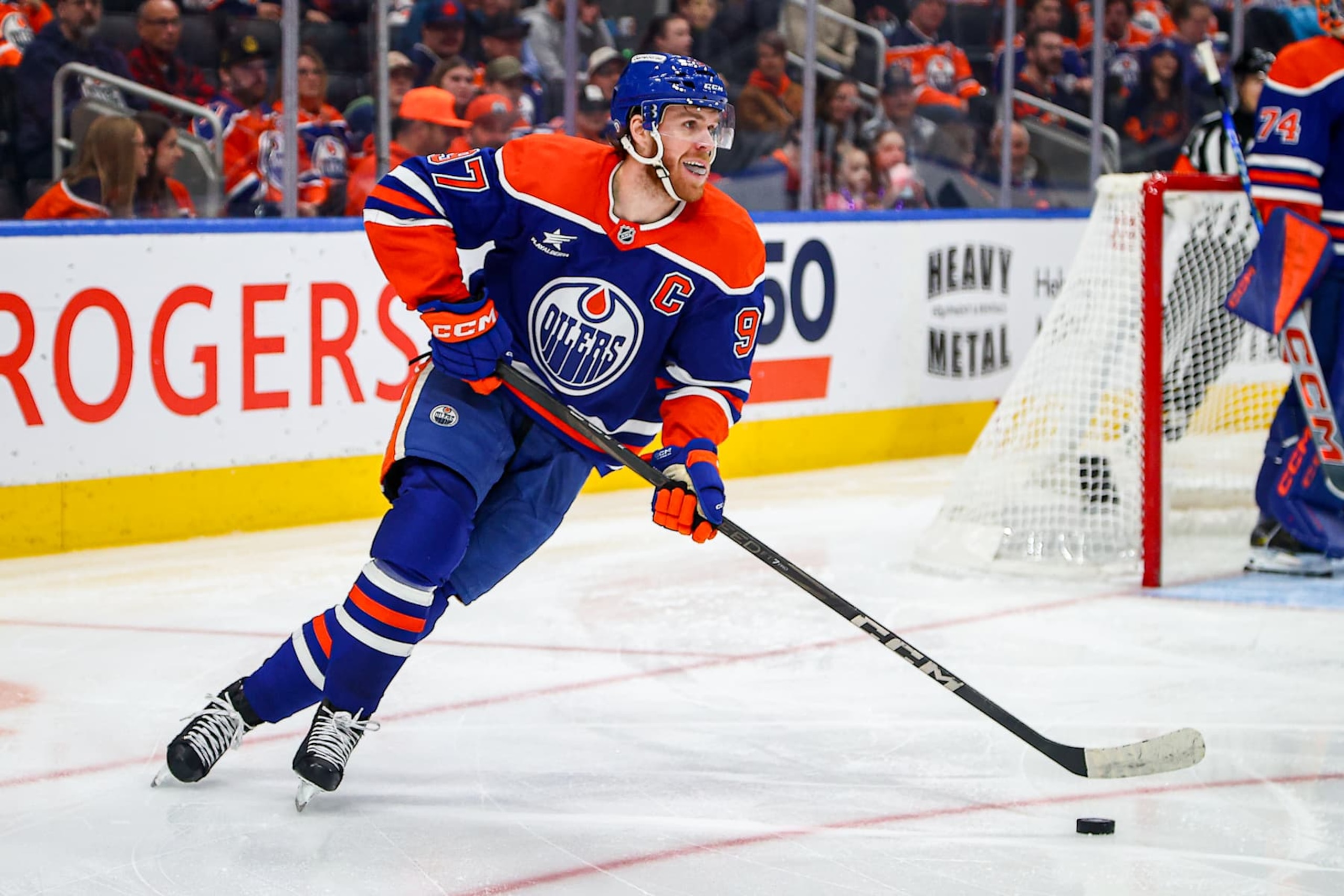 EDMONTON, AB - DECEMBER 07: Edmonton Oilers Center Connor McDavid (97) breaks the puck out of the zone in the second period of the Edmonton Oilers game versus the St.Louis Blues  on December 7, 2024 at Rogers Place in Edmonton, AB. (Photo by Curtis Comeau/Icon Sportswire via Getty Images)
