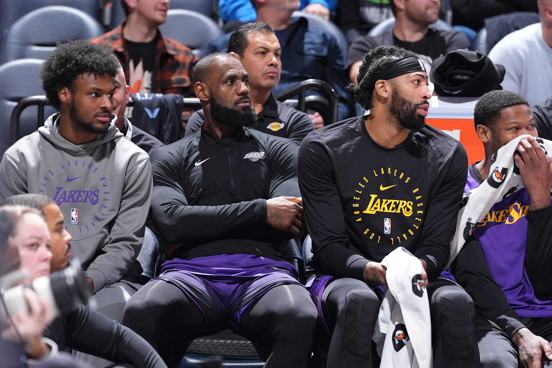 MINNEAPOLIS, MN - DECEMBER 2: Bronny James #9, LeBron James #23 and Anthony Davis #3 of the Los Angeles Lakers look on during the game against the Minnesota Timberwolves on December 2, 2024 at Target Center in Minneapolis, Minnesota. NOTE TO USER: User expressly acknowledges and agrees that, by downloading and or using this Photograph, user is consenting to the terms and conditions of the Getty Images License Agreement. Mandatory Copyright Notice: Copyright 2024 NBAE (Photo by Jordan Johnson/NBAE via Getty Images)