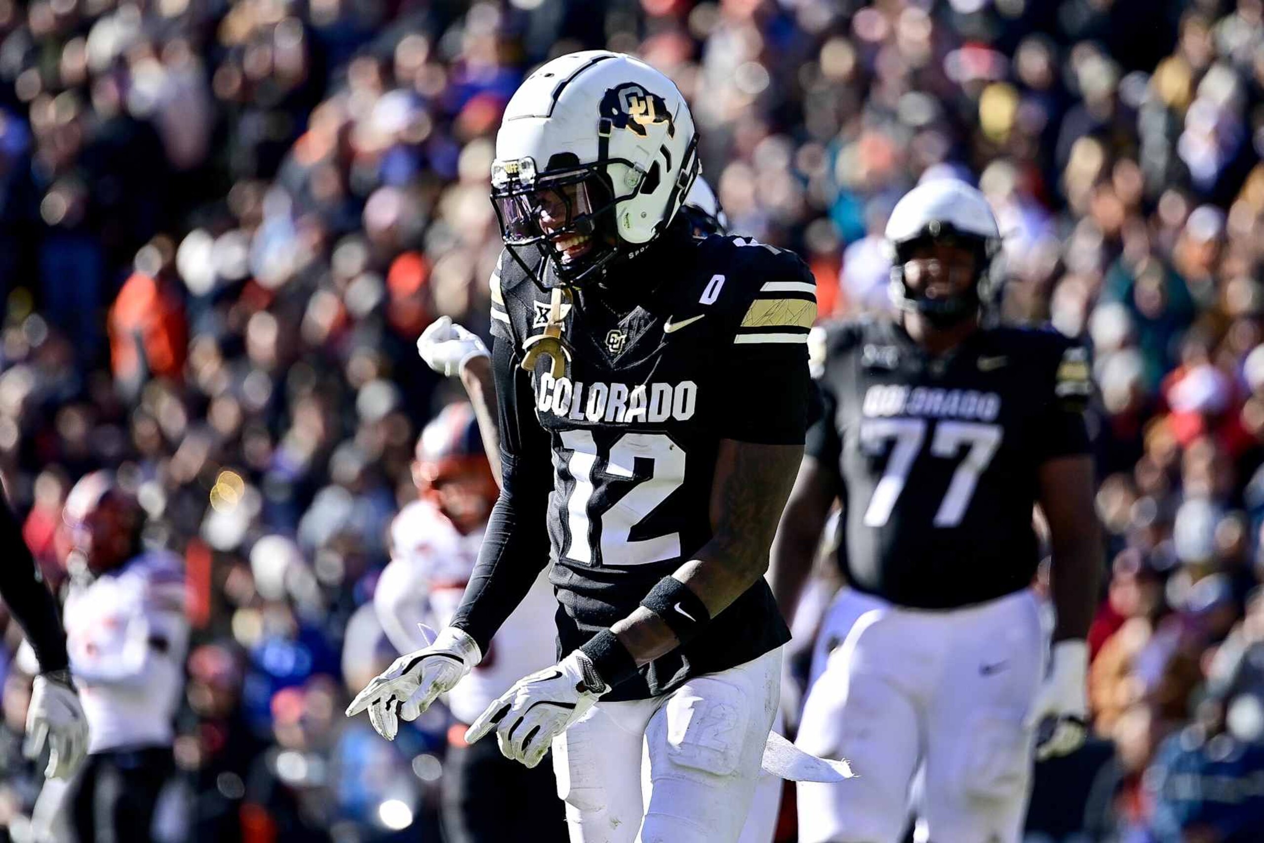 BOULDER, CO - NOVEMBER 29:  Travis Hunter #12 of the Colorado Buffaloes jogs on the field and celebrates after scoring a third quarter touchfown against the Oklahoma State Cowboys at Folsom Field on November 29, 2024 in Boulder, Colorado. (Photo by Dustin Bradford/Getty Images)