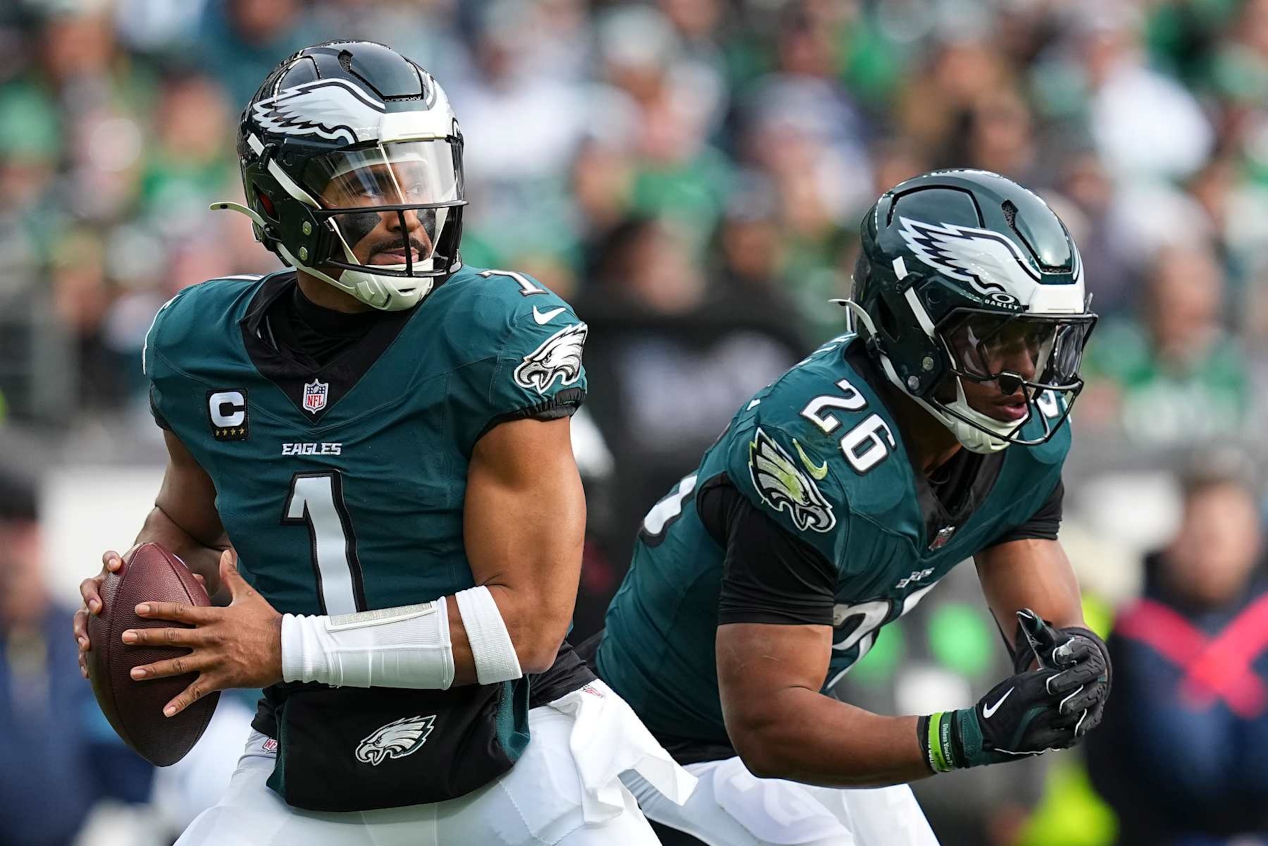 PHILADELPHIA, PENNSYLVANIA - DECEMBER 8: Jalen Hurts #1 and Saquon Barkley #26 of the Philadelphia Eagles in action against the Carolina Panthers at Lincoln Financial Field on December 8, 2024 in Philadelphia, Pennsylvania. (Photo by Mitchell Leff/Getty Images)
