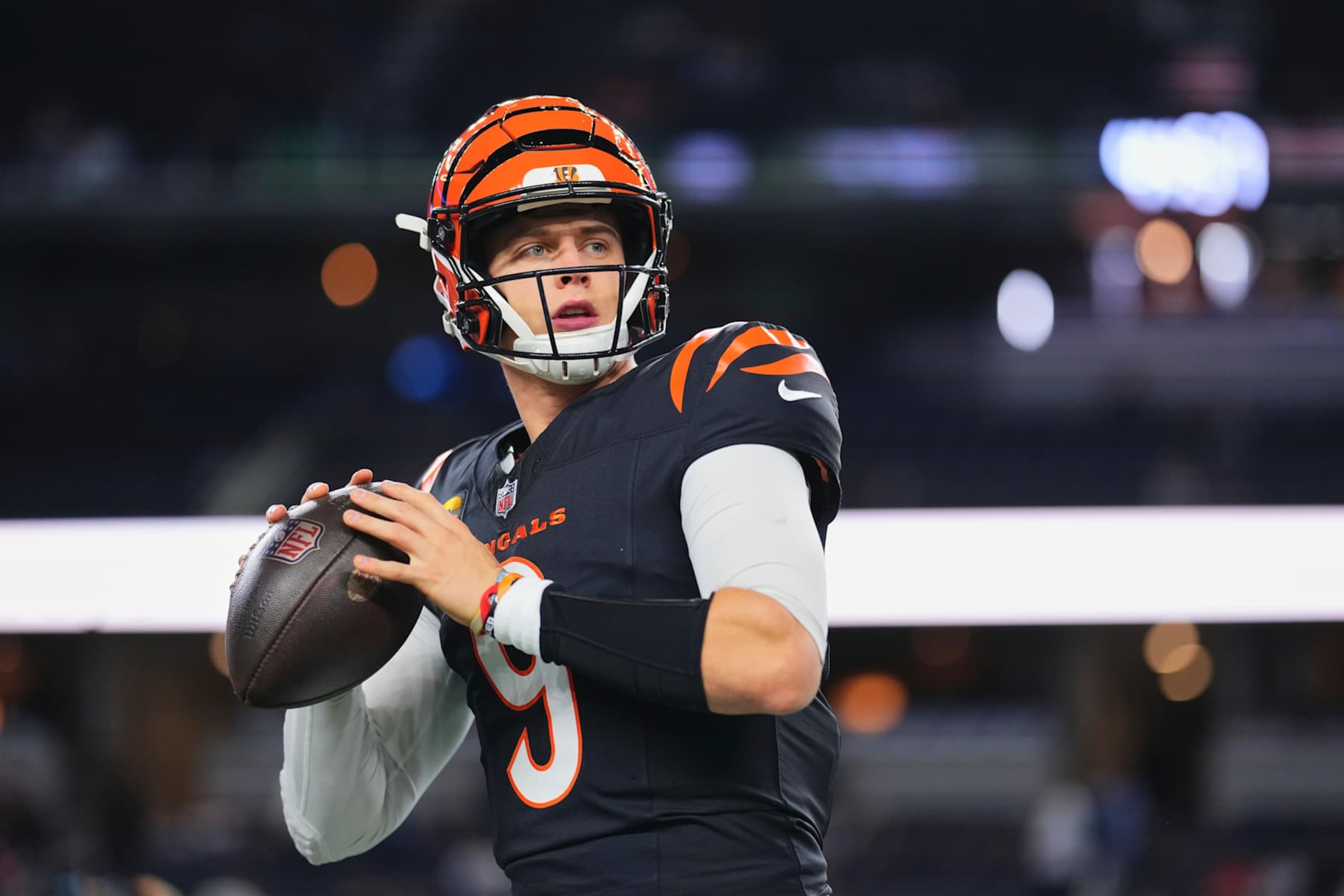 ARLINGTON, TX - DECEMBER 09: Joe Burrow #9 of the Cincinnati Bengals warms up before kickoff against the Dallas Cowboys during an NFL football game at AT&T Stadium on December 9, 2024 in Arlington, Texas. (Photo by Cooper Neill/Getty Images)
