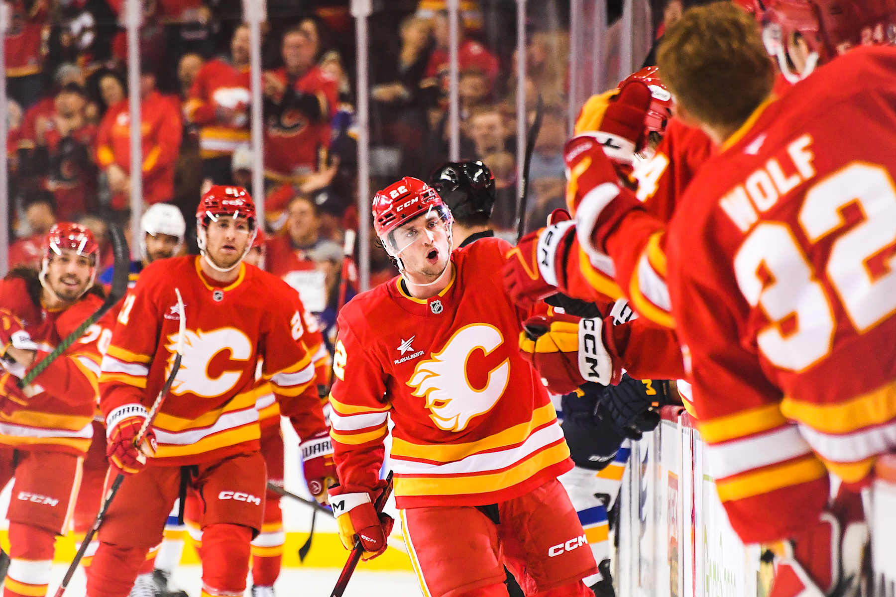 CALGARY, CANADA - DECEMBER 5: Jakob Pelletier #22 of the Calgary Flames celebrates with the bench after scoring against the St Louis Blues during the first period of an NHL game at Scotiabank Saddledome on December 5, 2024 in Calgary, Alberta, Canada.  (Photo by Derek Leung/Getty Images)