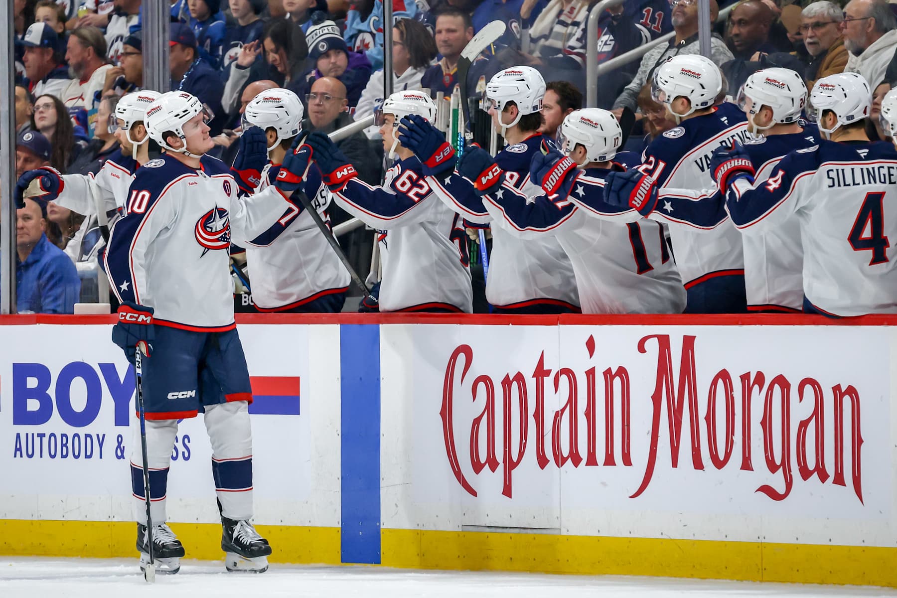 WINNIPEG, CANADA - DECEMBER 8: Dmitri Voronkov #10 of the Columbus Blue Jackets celebrates his second period goal against the Winnipeg Jets with teammates at the bench at the Canada Life Centre on December 8, 2024 in Winnipeg, Manitoba, Canada. (Photo by Jonathan Kozub/NHLI via Getty Images)