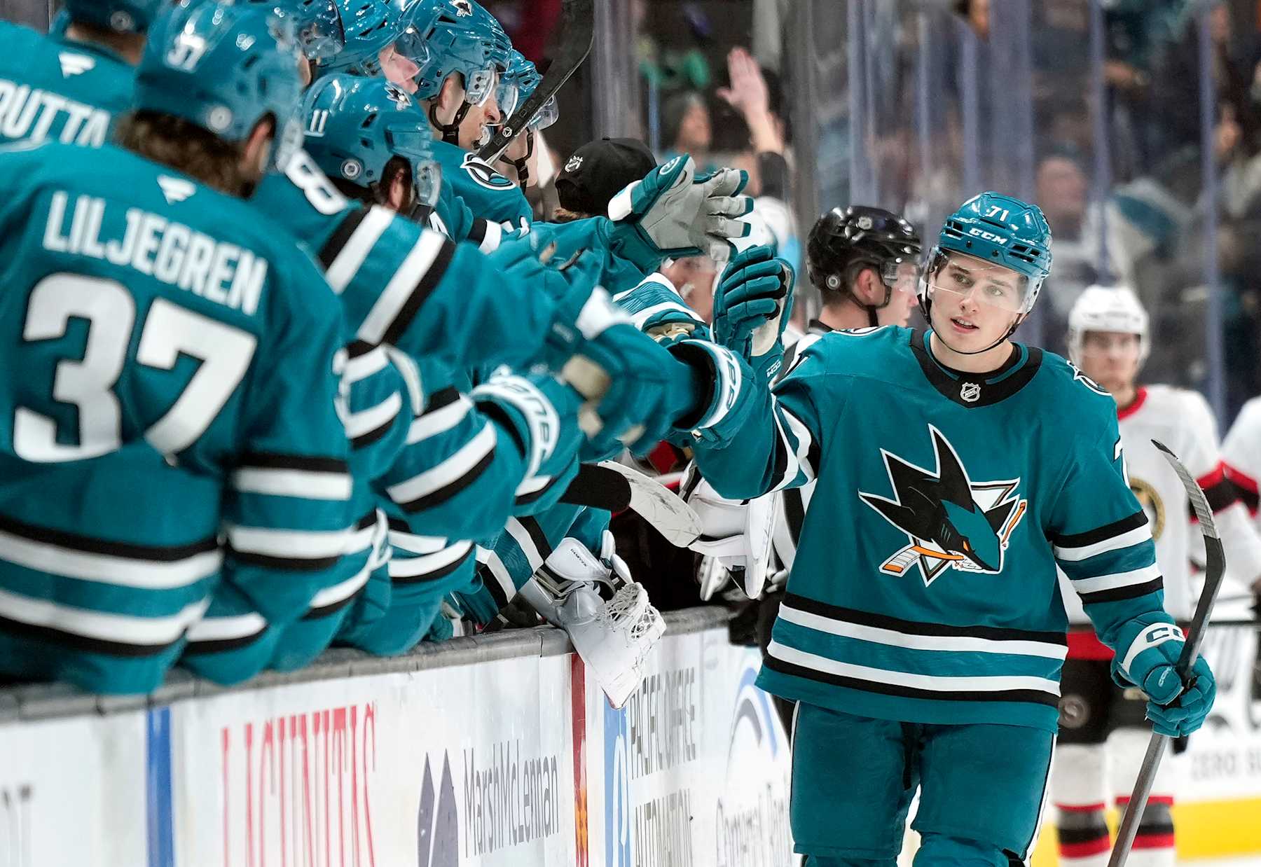 SAN JOSE, CALIFORNIA - NOVEMBER 27: Macklin Celebrini #71 of the San Jose Sharks is congratulated by teammates after he scored a goal against the Ottawa Senators during the third period of an NHL hockey game at SAP Center on November 27, 2024 in San Jose, California. (Photo by Thearon W. Henderson/Getty Images)
