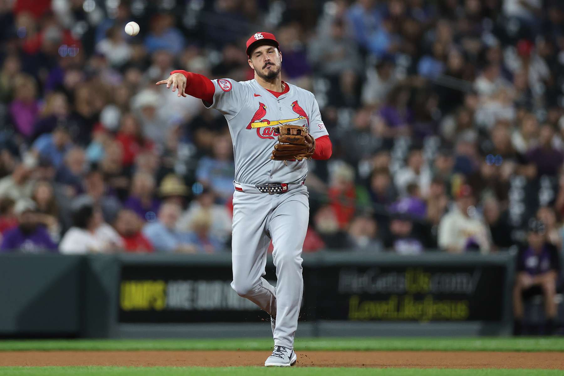 DENVER, COLORADO - SEPTEMBER 24: Nolan Arenado #28 of the St. Louis Cardinals throws out Brenton Doyle of the Colorado Rockies in the fourth inning at Coors Field on September 24, 2024 in Denver, Colorado. (Photo by Matthew Stockman/Getty Images)