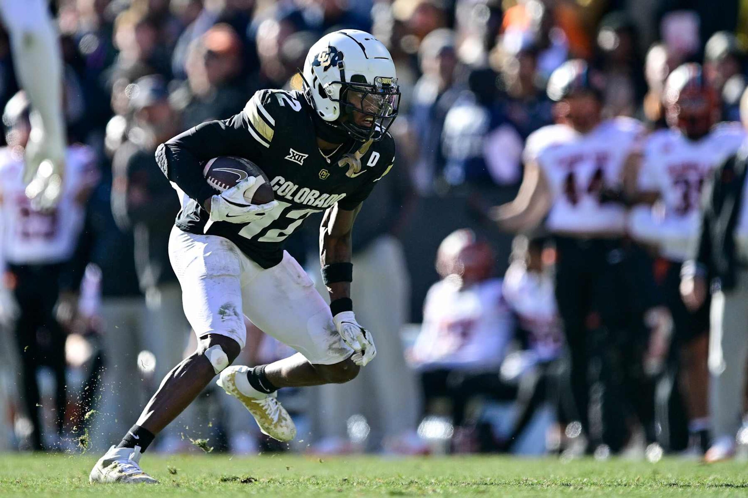 BOULDER, CO - NOVEMBER 29:  Travis Hunter #12 of the Colorado Buffaloes runs after a catch in the third quarter against the Oklahoma State Cowboys at Folsom Field on November 29, 2024 in Boulder, Colorado. (Photo by Dustin Bradford/Getty Images)