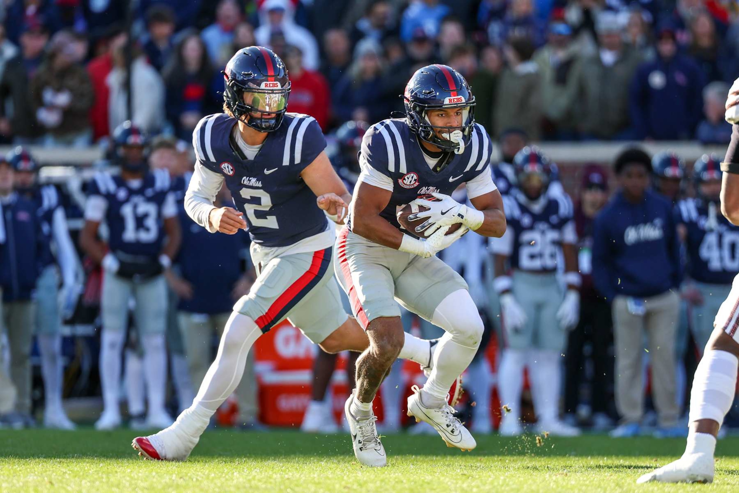 OXFORD, MISSISSIPPI - NOVEMBER 29: Jaxson Dart #2 of the Mississippi Rebels hands the ball to Micah Davis #4 during the first half against the Mississippi State Bulldogs at Vaught-Hemingway Stadium on November 29, 2024 in Oxford, Mississippi. (Photo by Wes Hale/Getty Images)