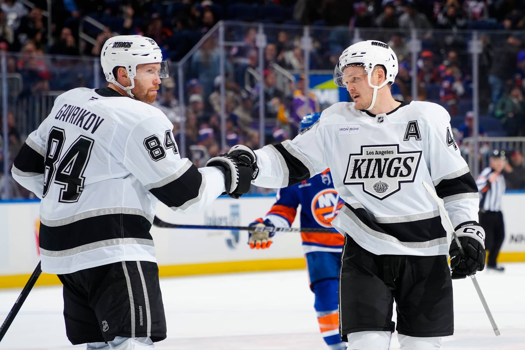 ELMONT, NEW YORK - DECEMBER 10:  Vladislav Gavrikov #84 and Mikey Anderson #44 of the Los Angeles Kings celebrate the teams win against the New York Islanders at UBS Arena on December 10, 2024 in Elmont, New York. (Photo by Mike Stobe/NHLI via Getty Images)