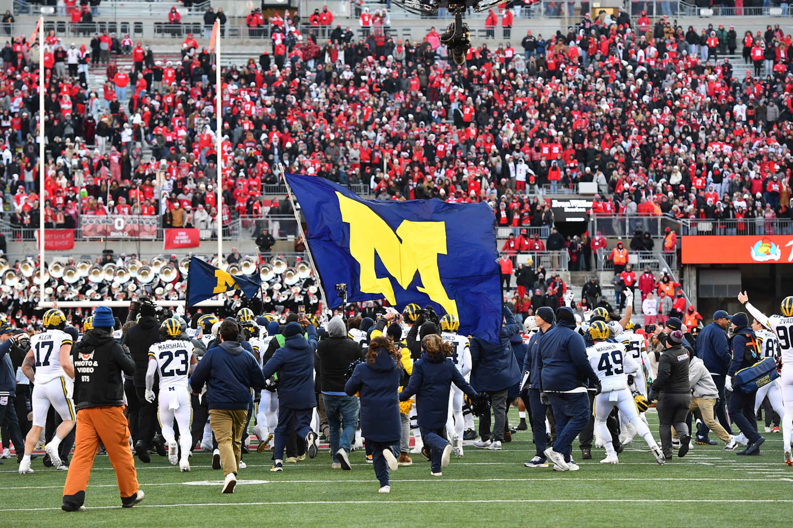COLUMBUS, OHIO - NOVEMBER 30: Michigan Wolverines players fly a flag prior to a brawl between players from both teams following a 13-10 Michigan win against the Ohio State Buckeyes at Ohio Stadium on November 30, 2024 in Columbus, Ohio. (Photo by Ben Jackson/Getty Images)