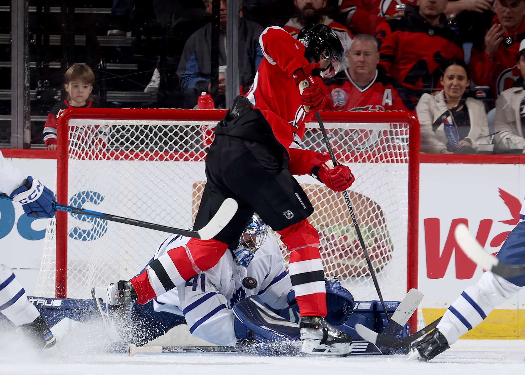 NEWARK, NEW JERSEY - DECEMBER 10:  Anthony Stolarz #41 of the Toronto Maple Leafs stops a shot from Luke Hughes #43 of the New Jersey Devils in the third period at Prudential Center on December 10, 2024 in Newark, New Jersey. The Toronto Maple Leafs defeated the New Jersey Devils 2-1 in overtime. (Photo by Elsa/Getty Images)