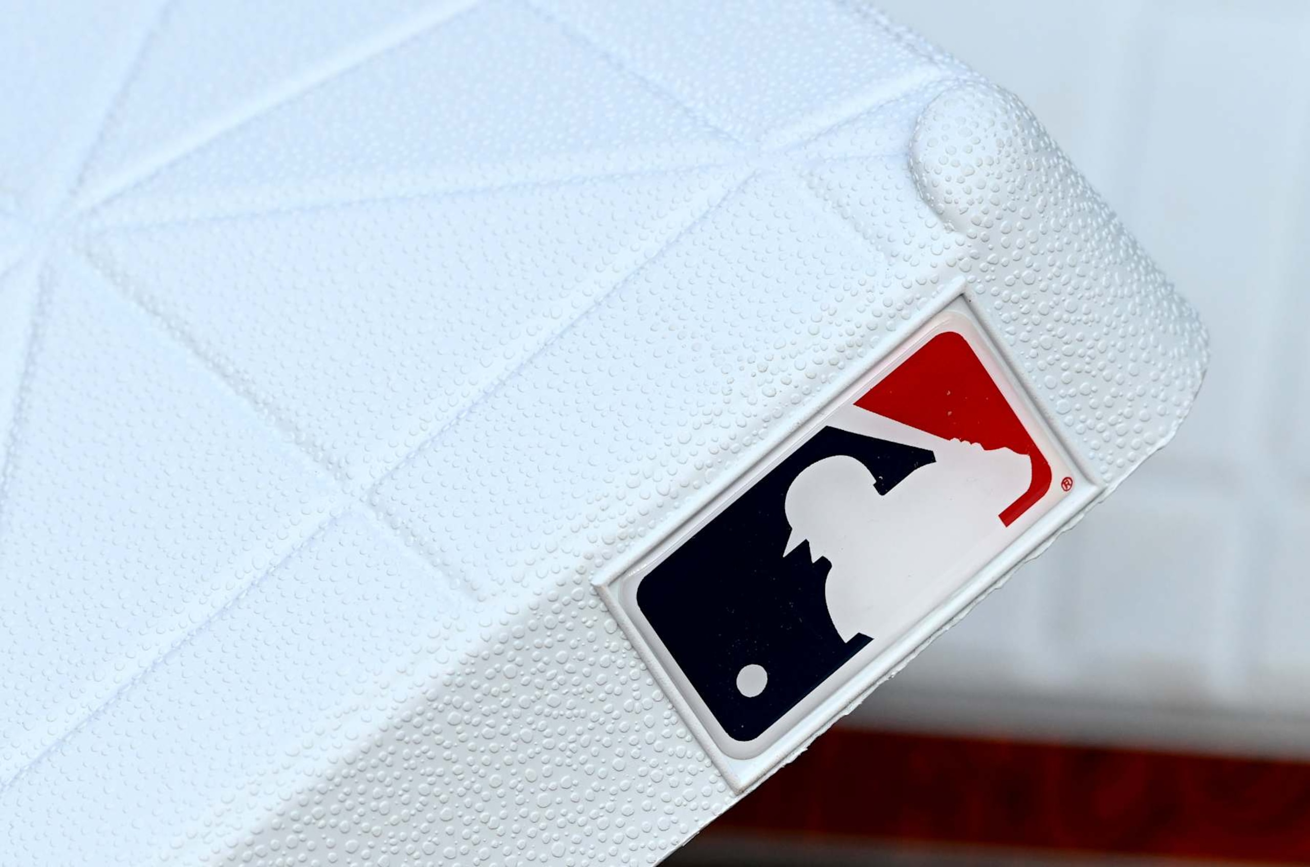 BALTIMORE, MARYLAND - AUGUST 15: A view of the MLB logo on a base before the game between the Baltimore Orioles and the Boston Red Sox at Oriole Park at Camden Yards on August 15, 2024 in Baltimore, Maryland. (Photo by G Fiume/Getty Images)