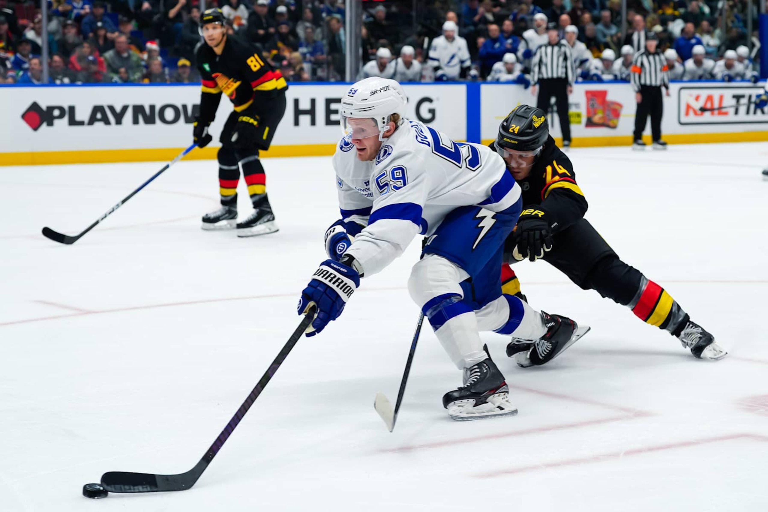 VANCOUVER, CANADA - DECEMBER 8: Jake Guentzel #59 of the Tampa Bay Lightning is checked by Pius Suter #24 of the Vancouver Canucks during the second period of their NHL game at Rogers Arena on December 8, 2024 in Vancouver, British Columbia, Canada. (Photo by Derek Cain/Getty Images) VANCOUVER, CANADA - DECEMBER 8: Jake Guentzel #59 of the Tampa Bay Lightning is checked by Pius Suter #24 of the Vancouver Canucks during the second period of their NHL game at Rogers Arena on December 8, 2024 in Vancouver, British Columbia, Canada. (Photo by Derek Cain/Getty Images)
