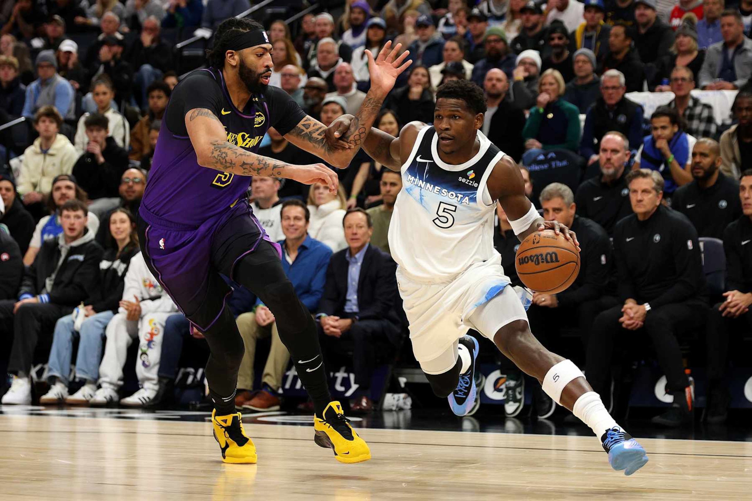 MINNEAPOLIS, MINNESOTA - DECEMBER 02: Anthony Edwards #5 of the Minnesota Timberwolves goes to the basket against Anthony Davis #3 of the Los Angeles Lakers in the first quarter at Target Center on December 02, 2024 in Minneapolis, Minnesota. NOTE TO USER: User expressly acknowledges and agrees that, by downloading and or using this photograph, User is consenting to the terms and conditions of the Getty Images License Agreement. (Photo by David Berding/Getty Images)