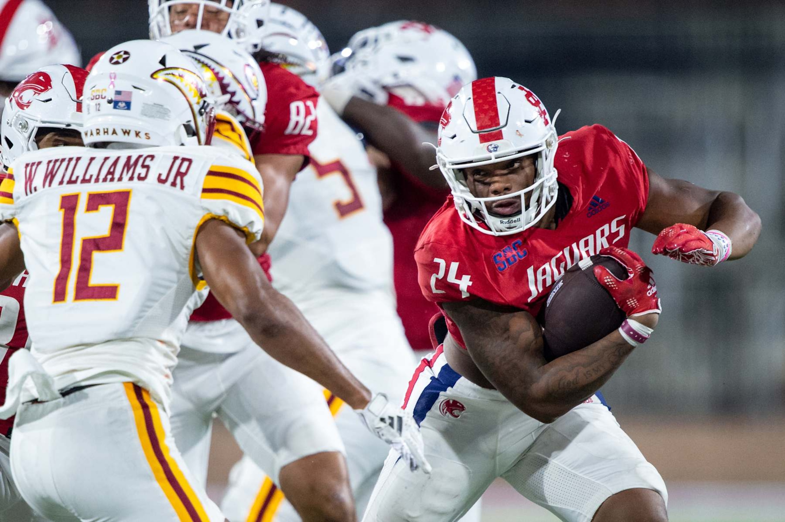 MOBILE, ALABAMA - OCTOBER 26: Running back Fluff Bothwell #24 of the South Alabama Jaguars looks to run the ball by defensive back Wydett Williams Jr. #12 of the Louisiana Monroe Warhawks at Hancock Whitney Stadium on October 26, 2024 in Mobile, Alabama. (Photo by Michael Chang/Getty Images)